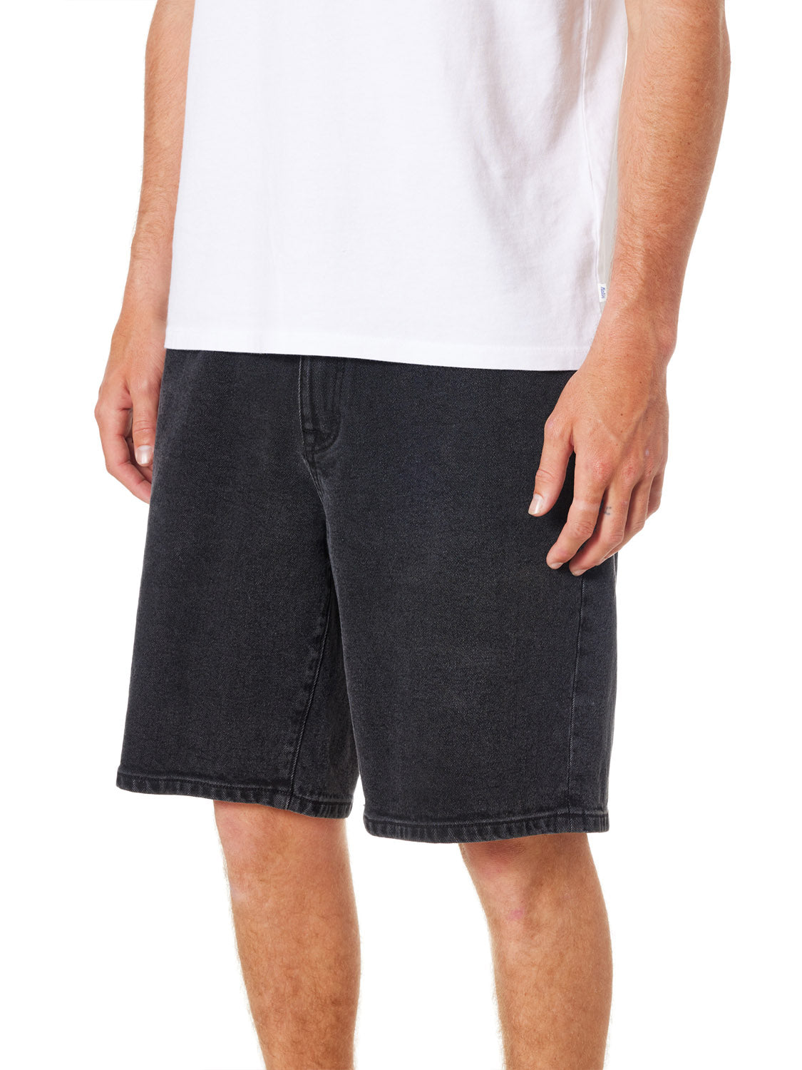 A person in a white T-shirt and black denim shorts, featuring the Katin George 64 Short - 20 in classic wash. These knee-length shorts have a relaxed fit suited for casual style against a plain white background.