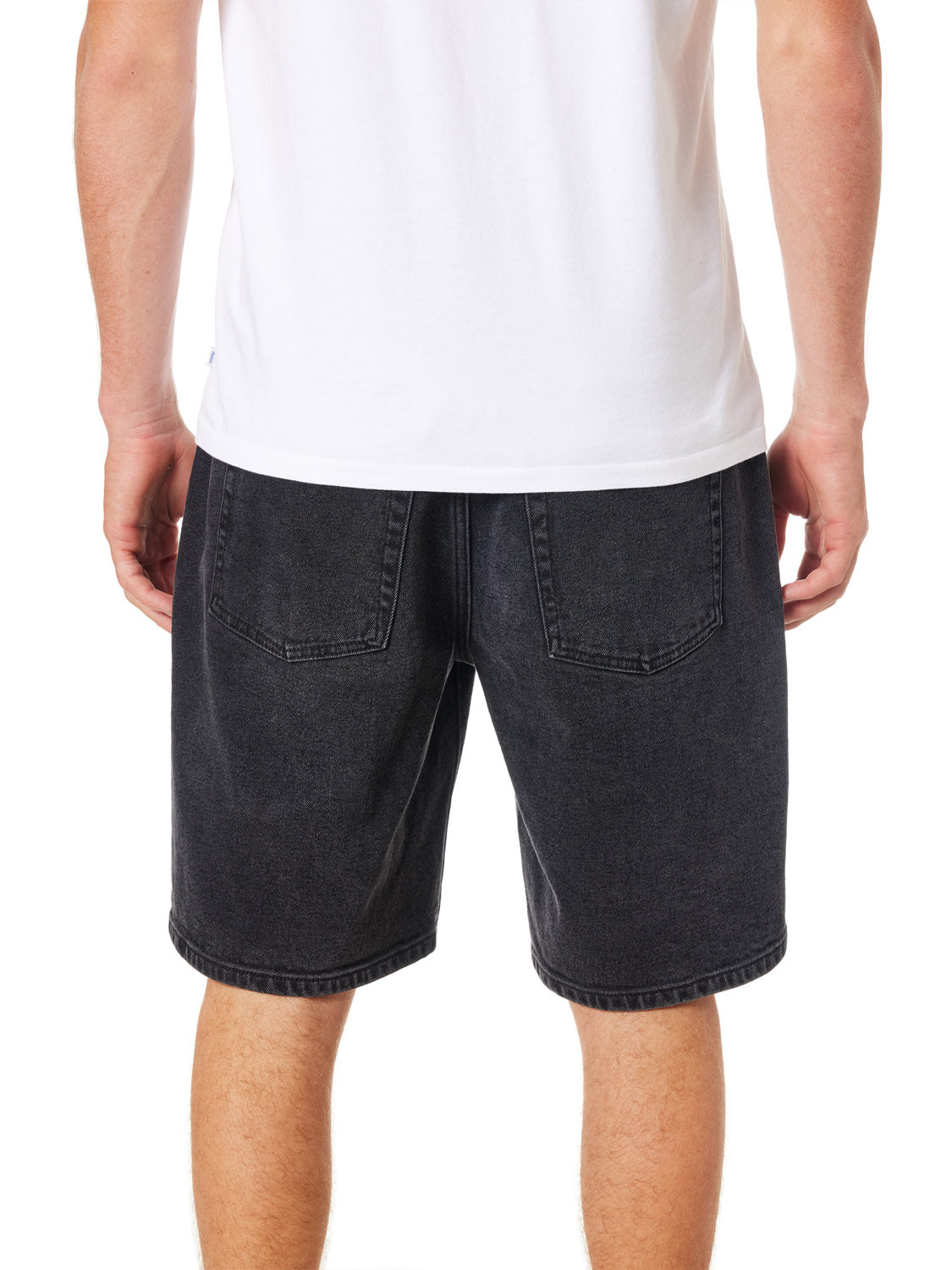 A person wearing a white T-shirt and Katins George 64 Short - 20 in a classic wash. The rear view showcases pocket and seam details, highlighting the shorts relaxed fit.