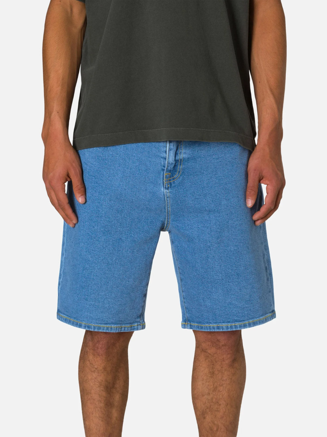 A person wears the Katin George 64 Short - 20", featuring a relaxed fit and classic five-pocket design in light blue denim, paired with a dark t-shirt, standing against a plain background with arms by their sides.