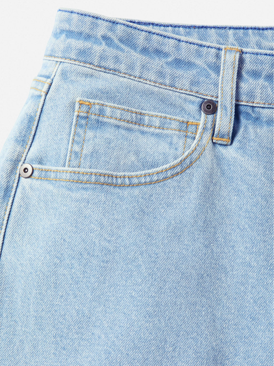 Close-up of the waist and pocket area of Katin's George 64 Relaxed Pants in light blue, featuring yellow stitching, a metal rivet, and a belt loop. These relaxed fit pants blend classic style with modern comfort against a white background.
