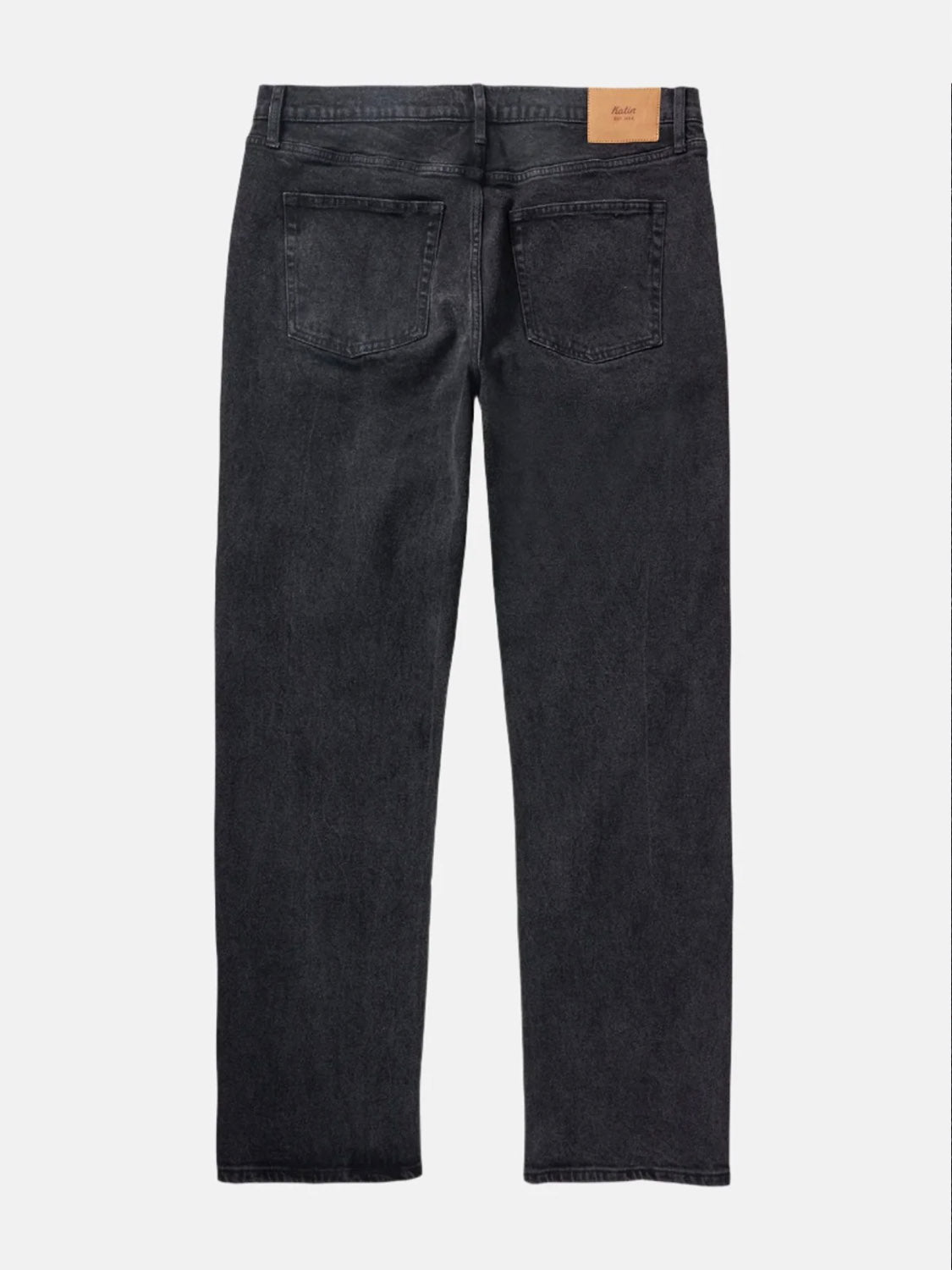 The Katin George 64 Relaxed Pants are black jeans with a classic 5-pocket design, two back pockets, belt loops, and a tan leather patch on the waistband, shown here from the back.