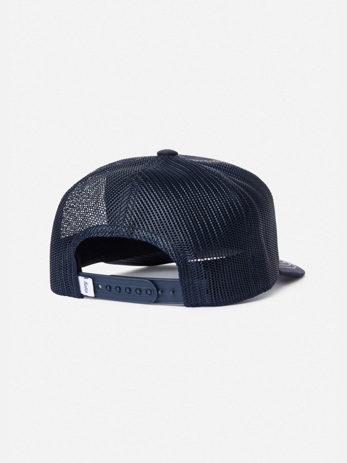 The Katin Good Times Trucker Hat is shown from the back in navy blue mesh, featuring an adjustable snapback and a small white tag on the strap, set against a plain white background.