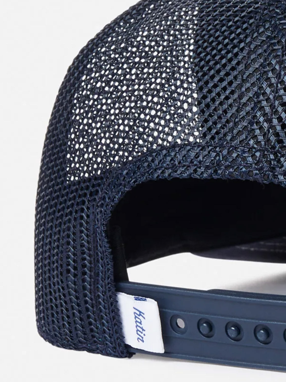 Close-up of the back of the Katin Good Times Trucker Hat in navy blue mesh with a snapback closure and a small white Katin tag.