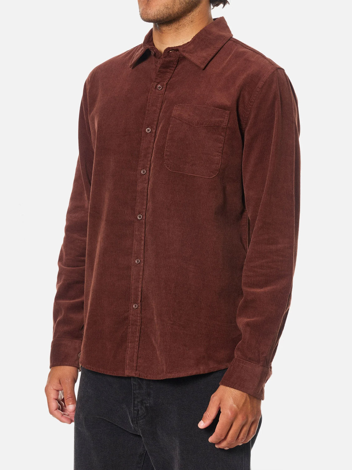 A person models the Katin Granada Shirt—a long-sleeve brown corduroy button-down with a chest pocket—against a plain white background. The focus is on the shirt, while the individual’s face is not shown.