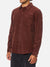 A person models the Katin Granada Shirt—a long-sleeve brown corduroy button-down with a chest pocket—against a plain white background. The focus is on the shirt, while the individual’s face is not shown.