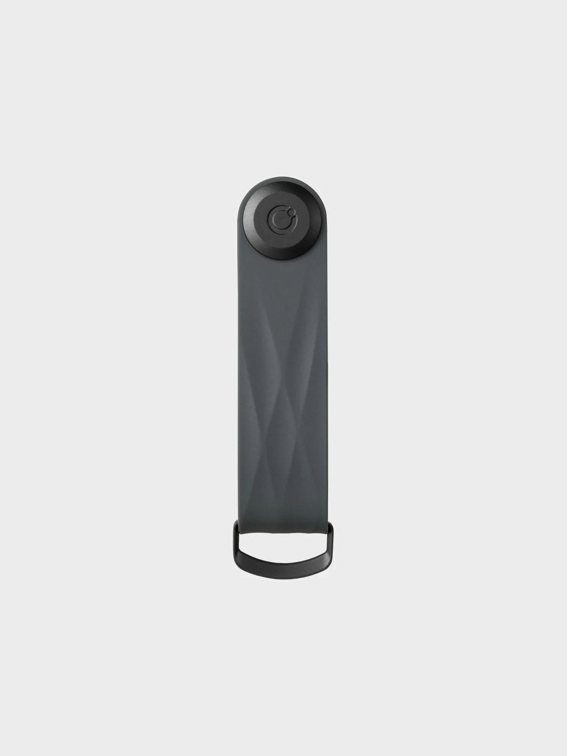 The Orbitkeys Key Organizer Rubber Active is a sleek black rectangular key stack featuring a circular button on top and a small loop at the bottom, displayed against a plain light gray background.