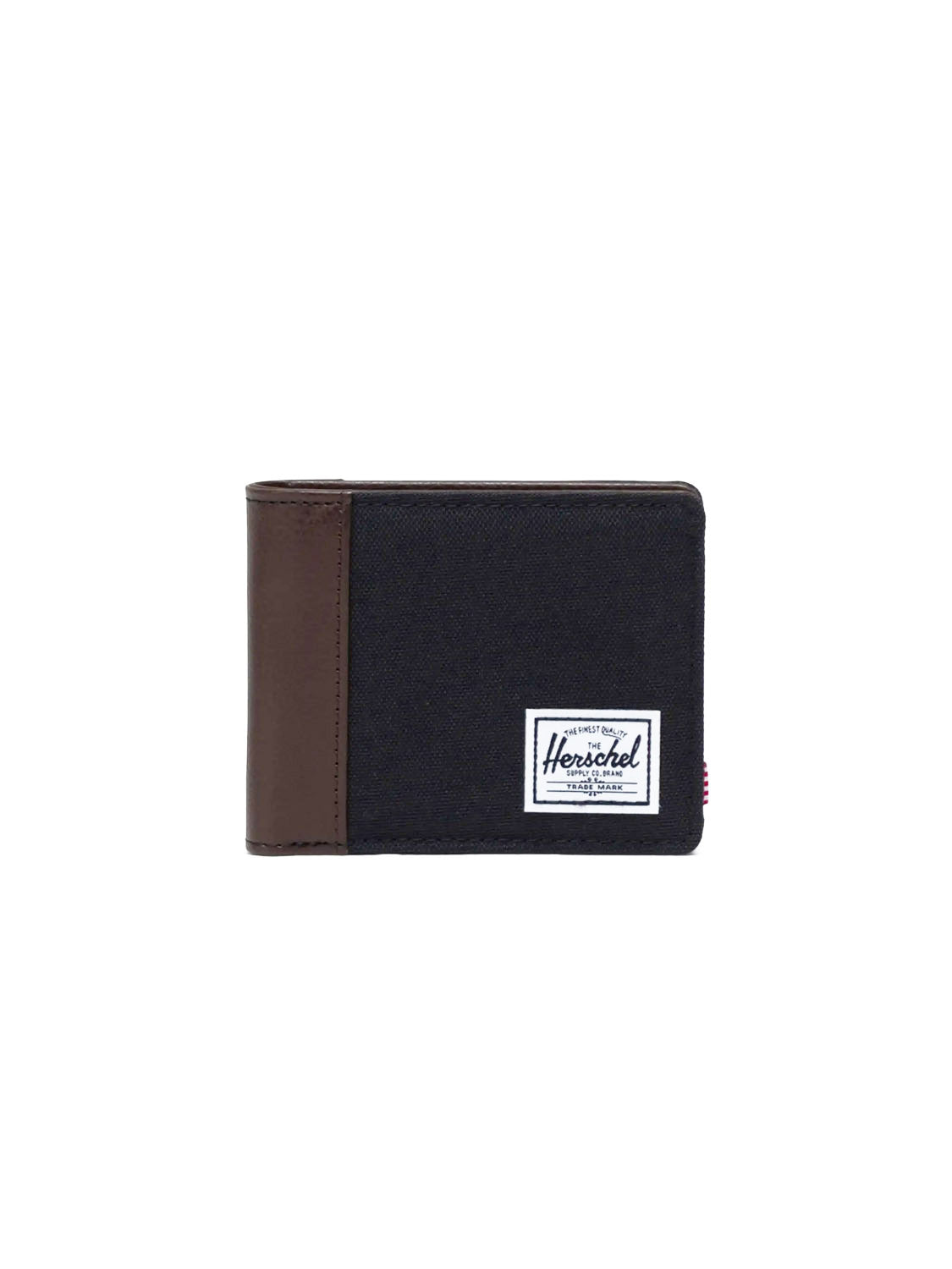 The Herschel Hank Wallet is a black fabric bi-fold with a brown synthetic leather accent on the left edge and a white rectangular Herschel label on the front, shown against a plain white background.