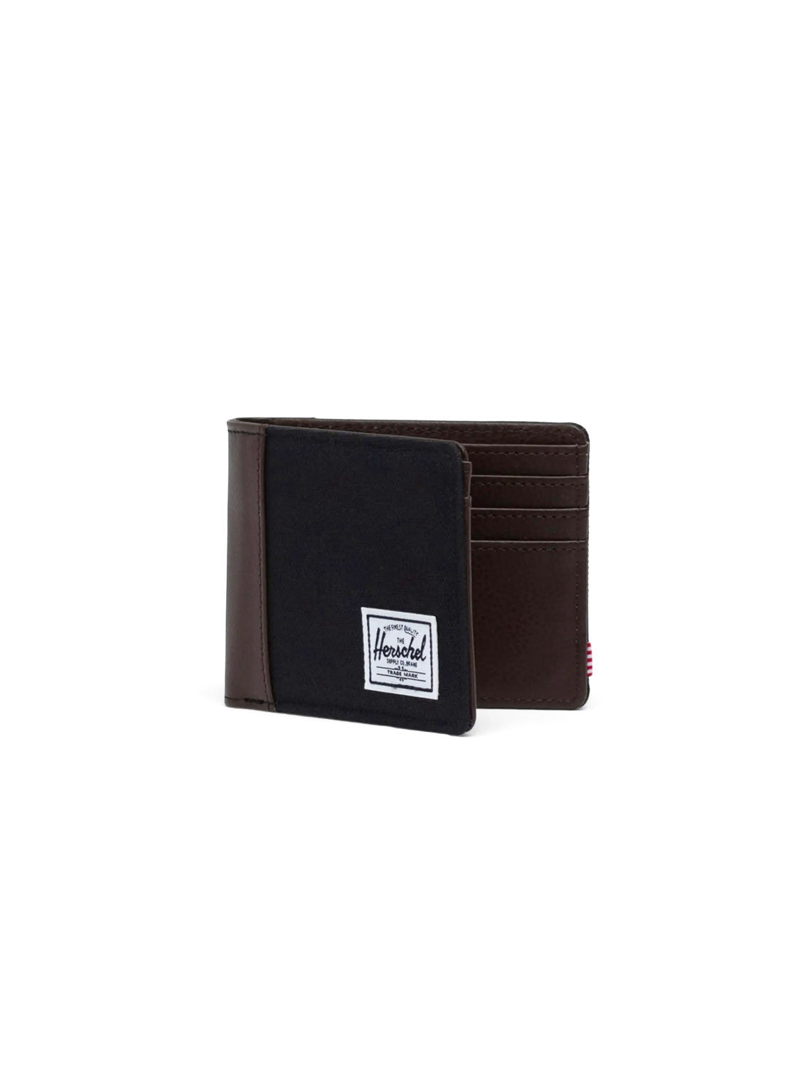 The Herschel Hank Wallet is a minimalist bi-fold made with dark brown synthetic leather and black fabric. It features card slots, RFID blocking, and a white rectangular Herschel logo patch on the front.