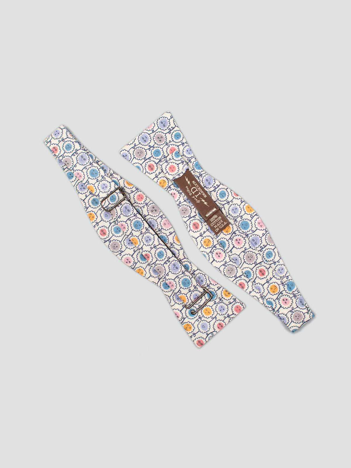 Two Liberty of London Tana Lawn™ Happy Bloom Bow Ties by ID Menswear, featuring a vibrant floral circle pattern on light cotton, are displayed side by side on a plain white surface.