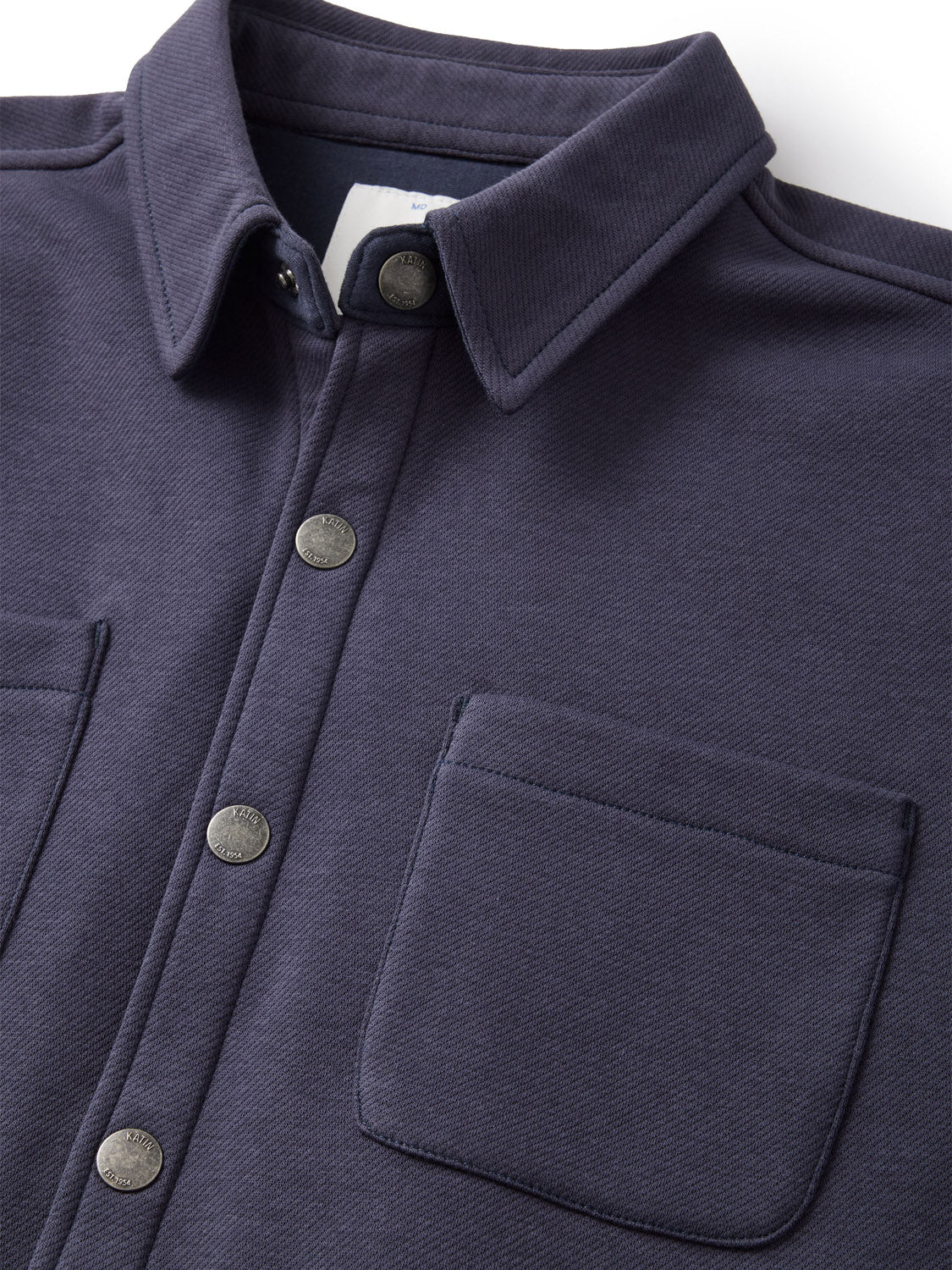 Close-up of a Katin navy blue Harold Fleece Jacket made from a poly-cotton blend, with snap closure, two chest pockets, and a textured fabric. It features a classic collar for a sleek finish.