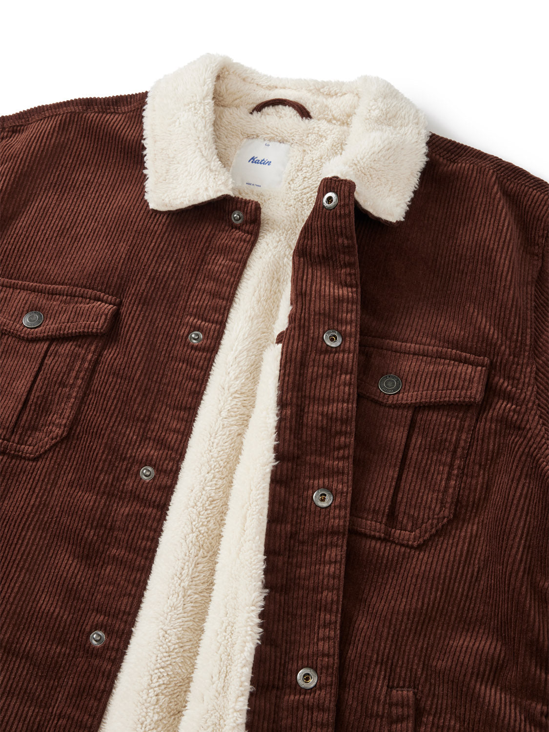 The Harris Corduroy Jacket by Katin features durable brown cotton, a cream sherpa lining and collar, metal buttons, and two front chest pockets with button flaps.