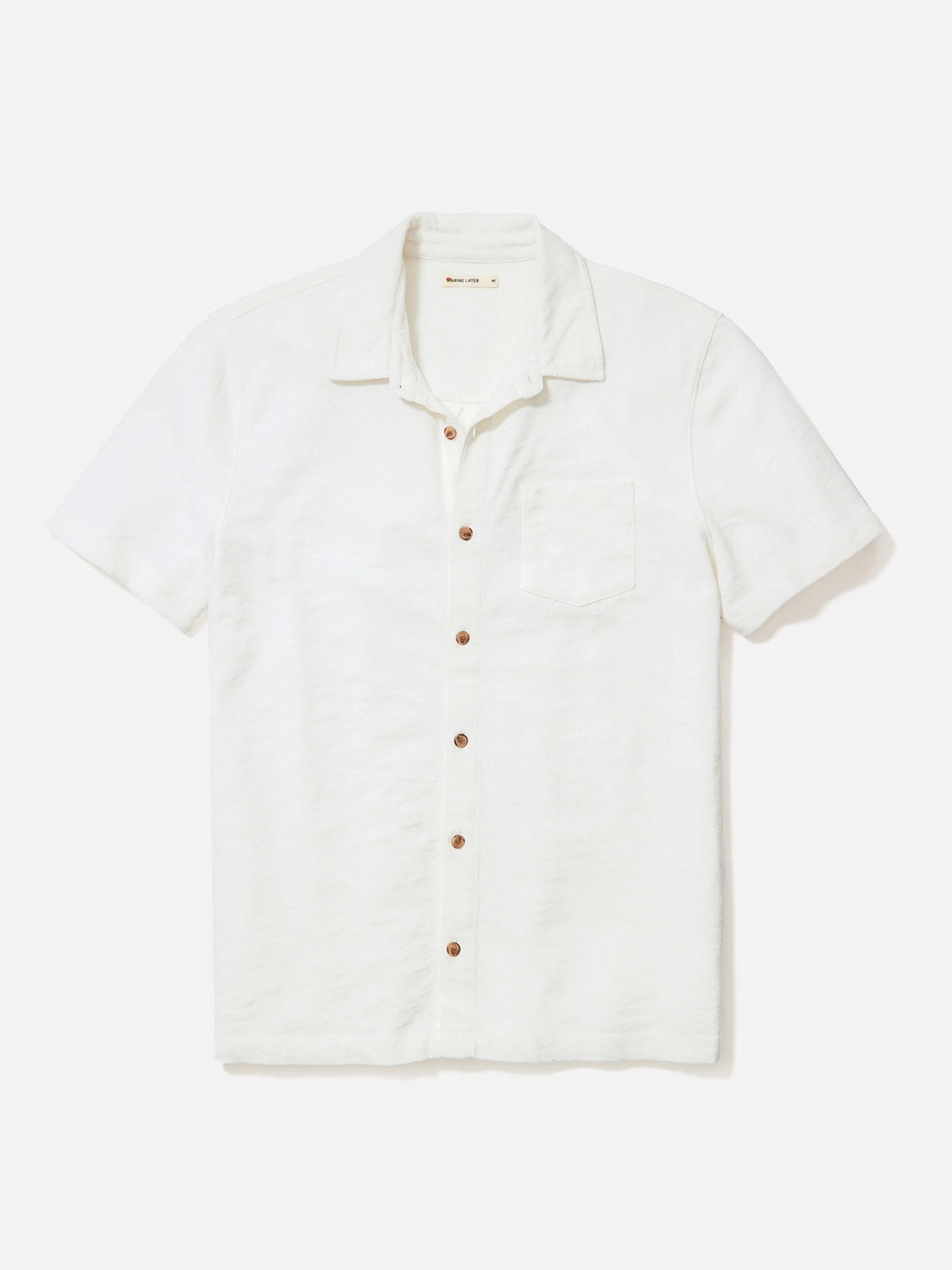 The Marine Layer Vintage Heavy Slub Button Down is a short-sleeve, white 100% cotton shirt with a collar and single chest pocket, garment-dyed for a unique finish and shown on a plain white background.