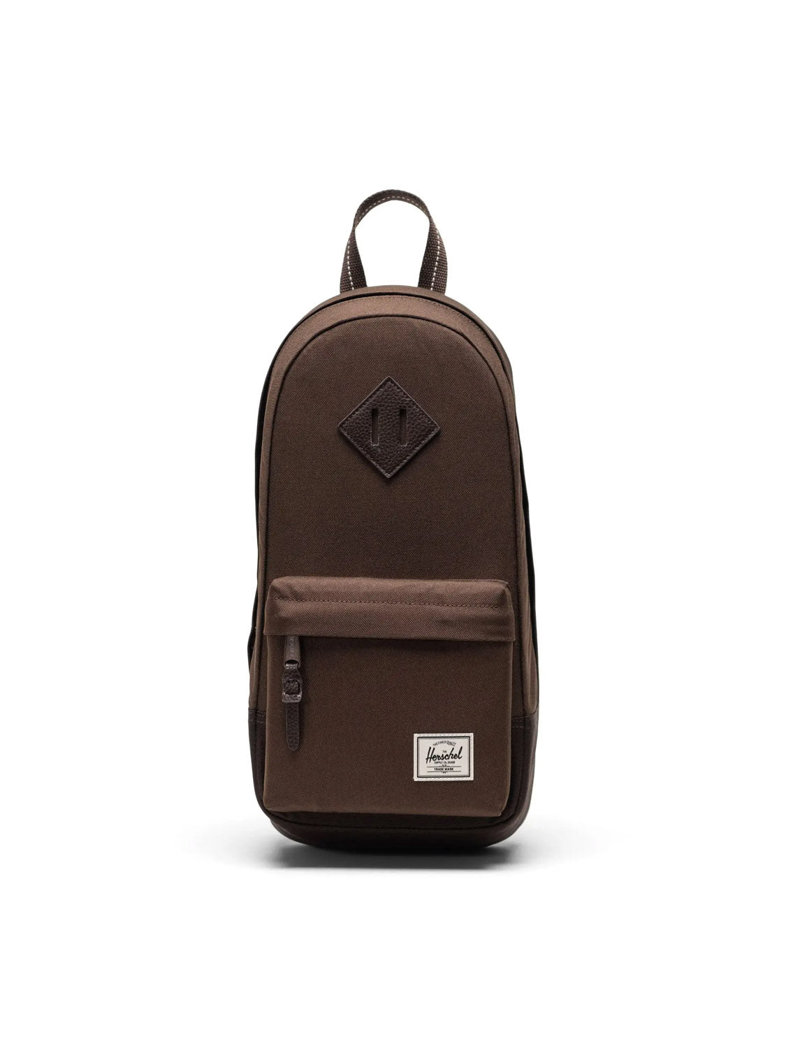 The Herschel Heritage Shoulder Bag - 8L is a brown minimalist bag made from recycled polyester, featuring a front zippered pocket, top handle, small white Herschel label, and a diamond-shaped patch near the top.