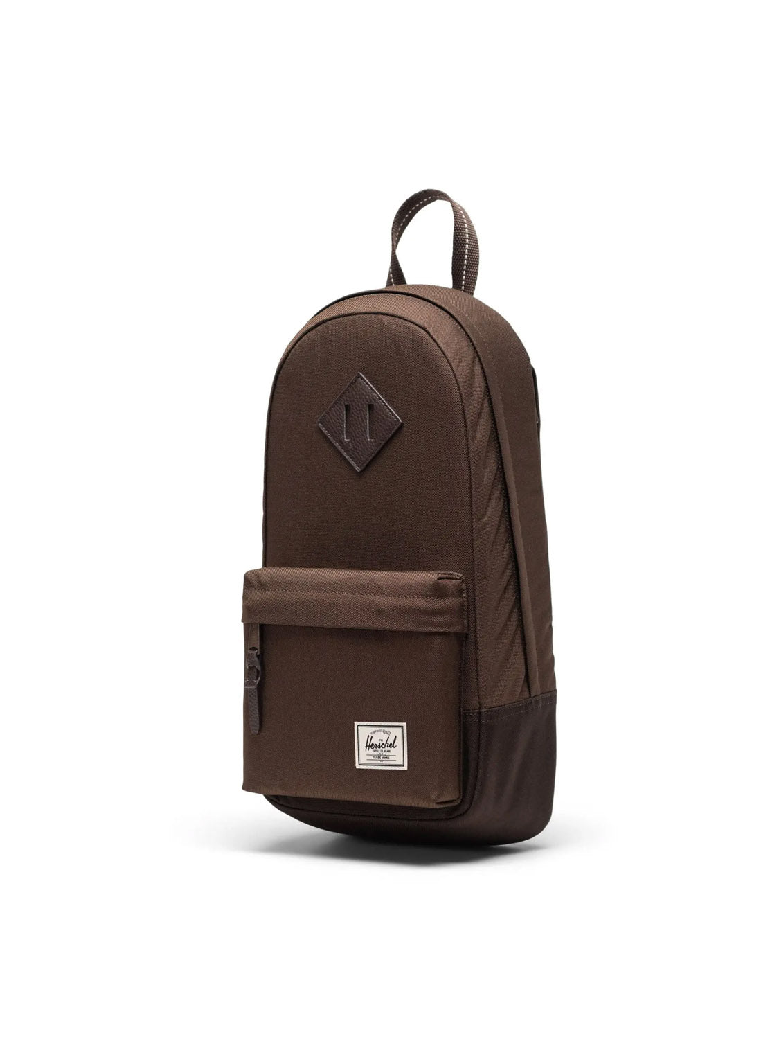 The Herschel Heritage Shoulder Bag - 8L, made from recycled polyester, features a brown color, front zip pocket, small white rectangular label, and top handle. It's displayed against a plain white background.