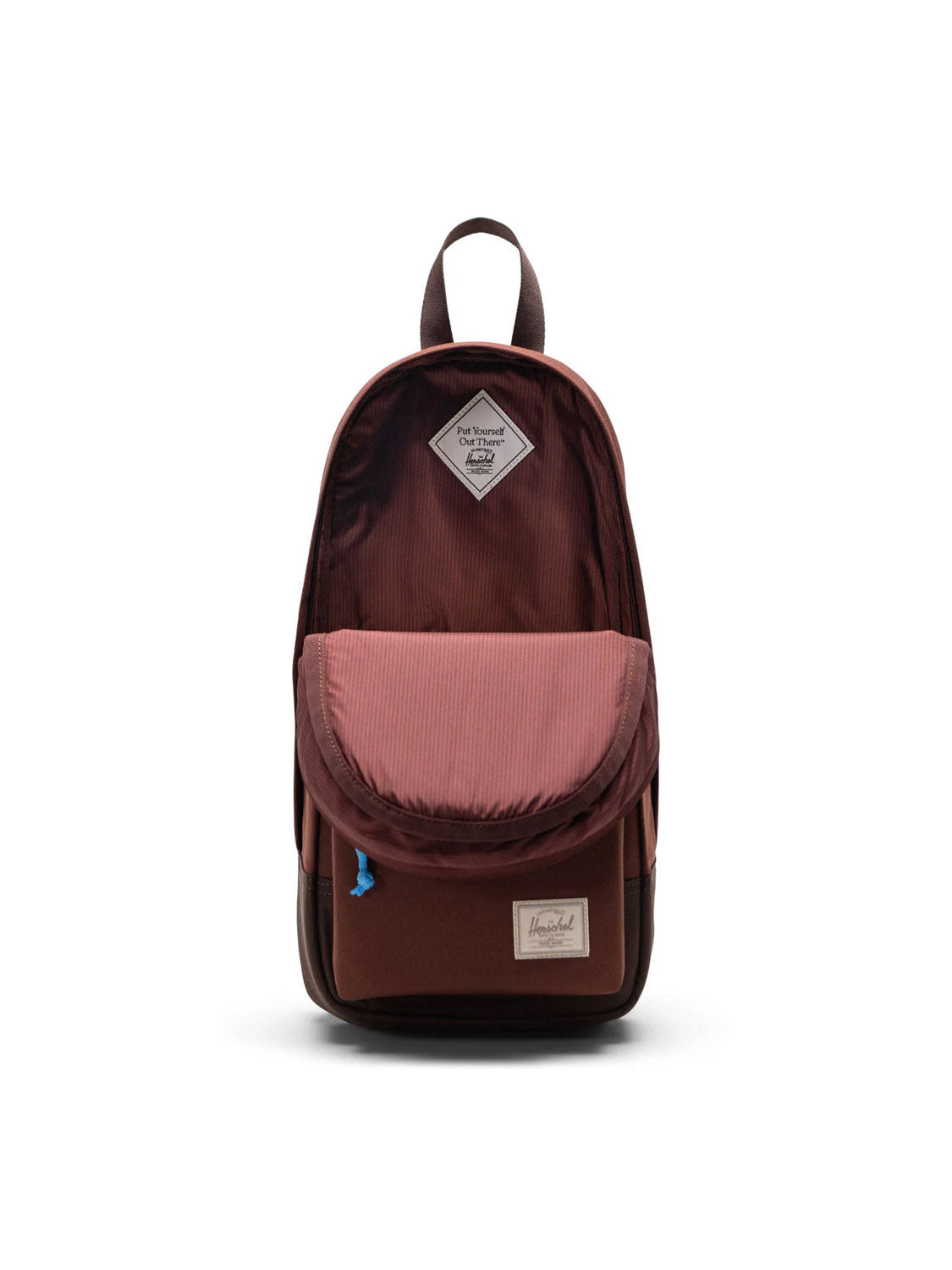 The Herschel Heritage Shoulder Bag - 8L, in maroon and brown, features a front pocket, top carrying handle, and branded label on the lower front. This crossbody bag is shown upright against a white background.