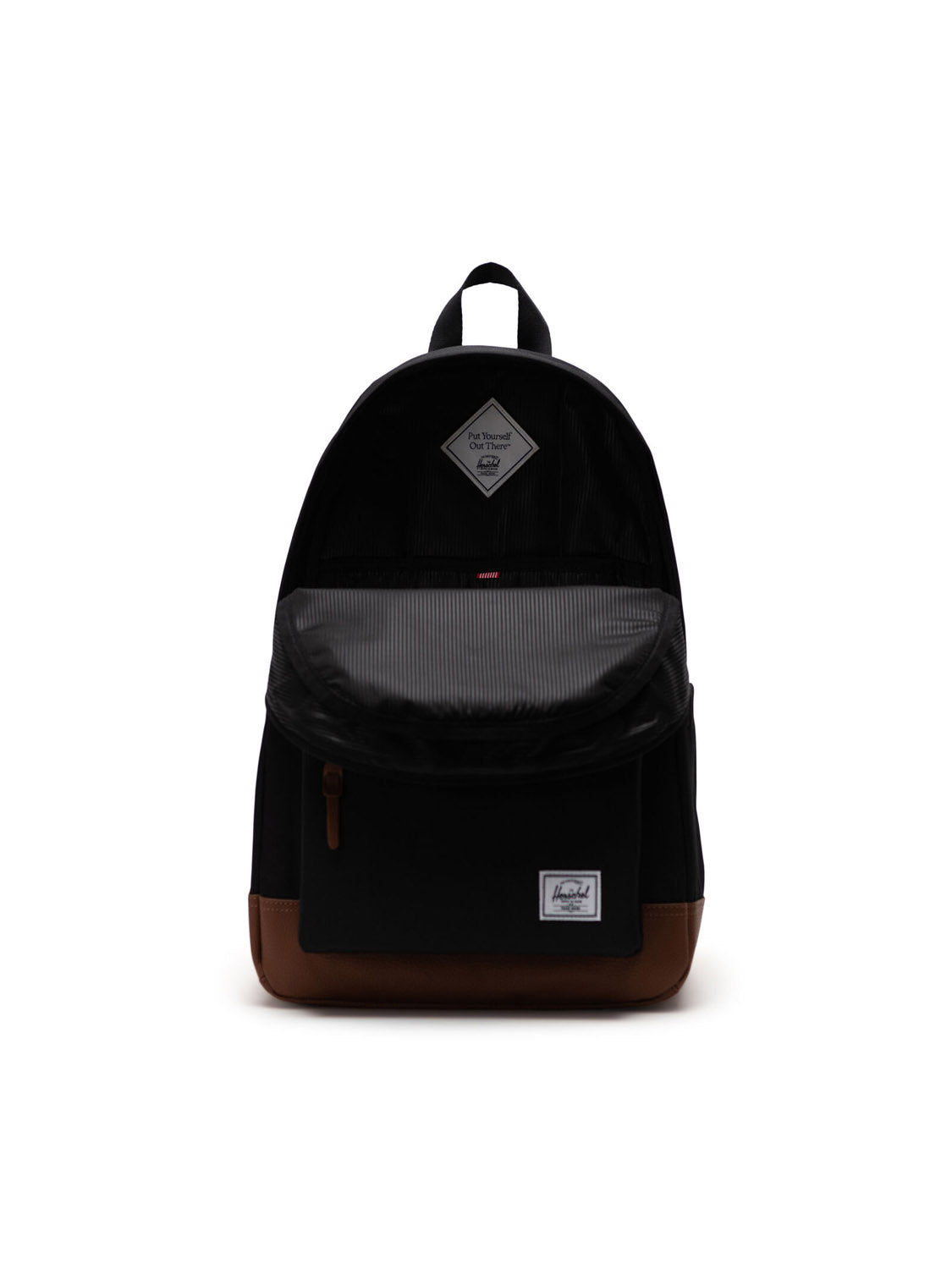 The Herschel Heritage Backpack, shown in black with brown leather accents, features a front zipper pocket, top handle, adjustable straps, and a logo patch near the bottom, with its main compartment partially open.