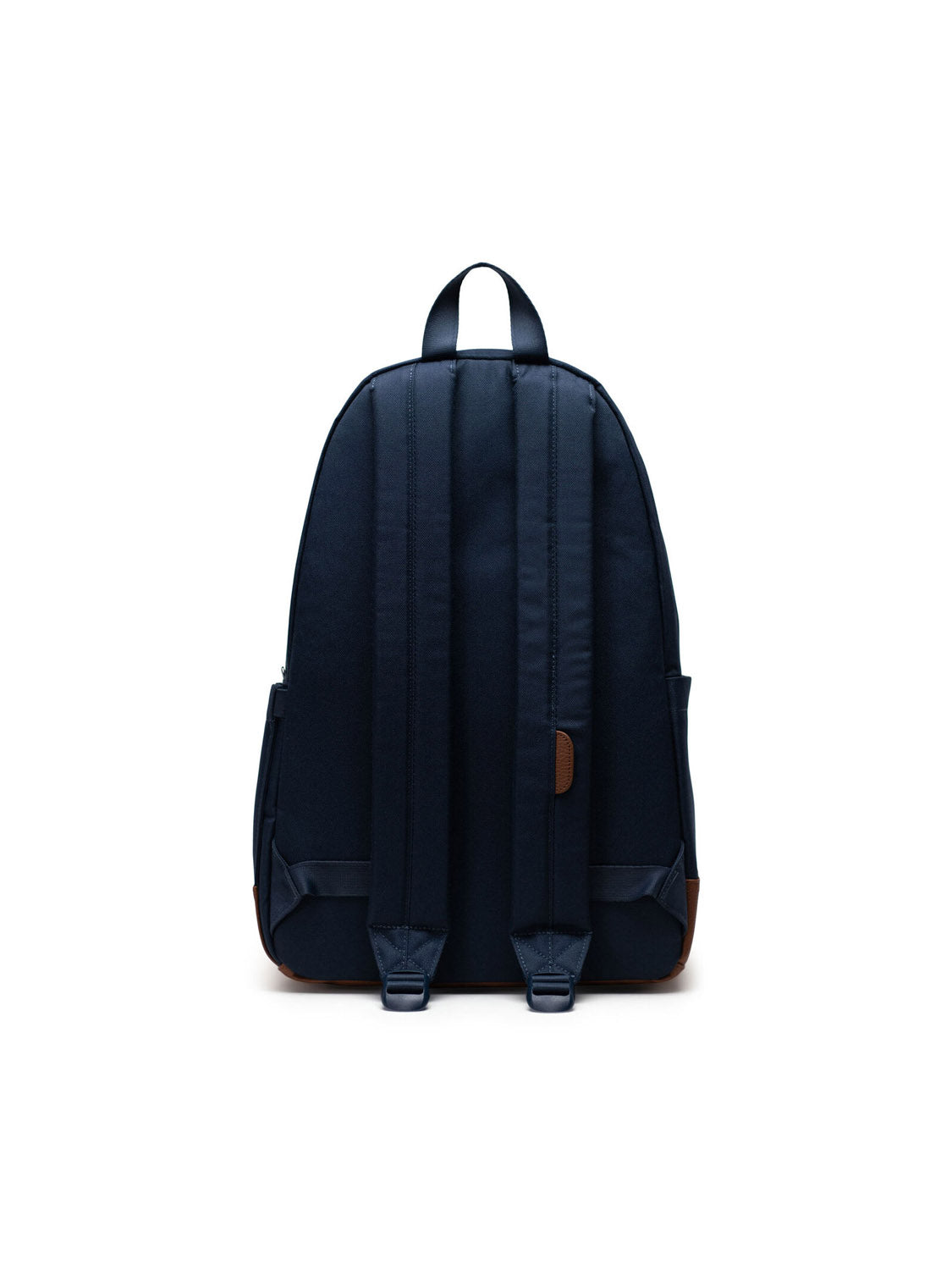The Herschel Heritage Backpack in dark navy is shown from the back, displaying adjustable padded shoulder straps, a top handle, and brown corner accents, all set against a white background.