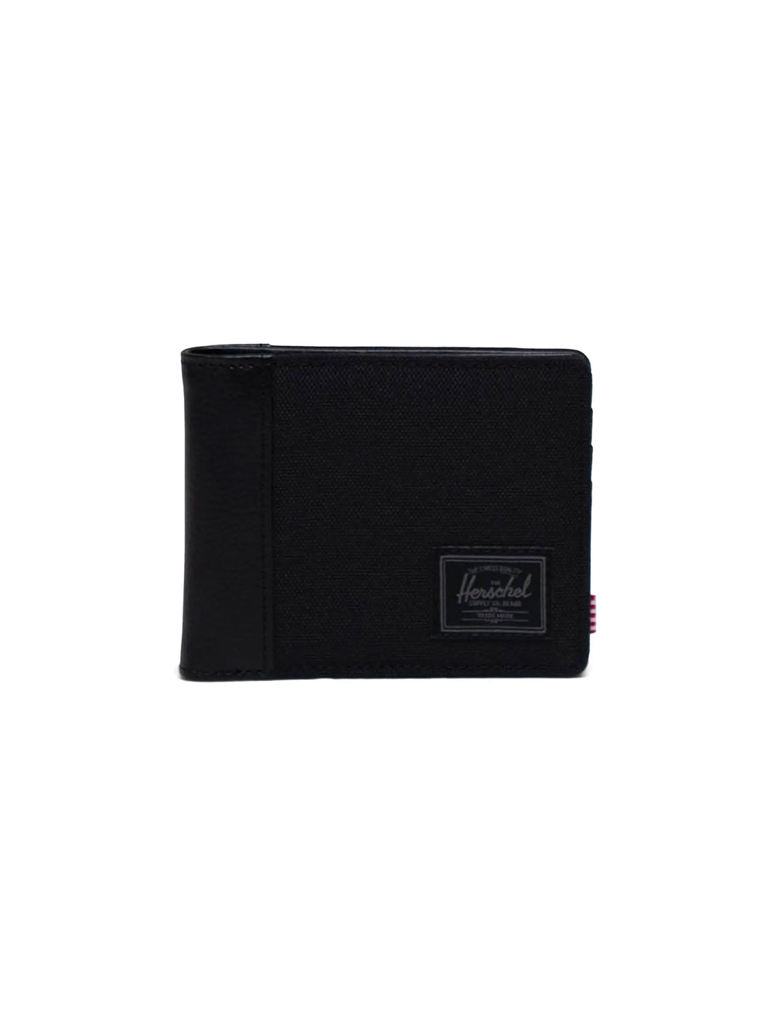 The Herschel Hank Wallet, a black bi-fold with multiple card slots and a rectangular stitched logo patch on the front, is displayed upright against a plain white background.