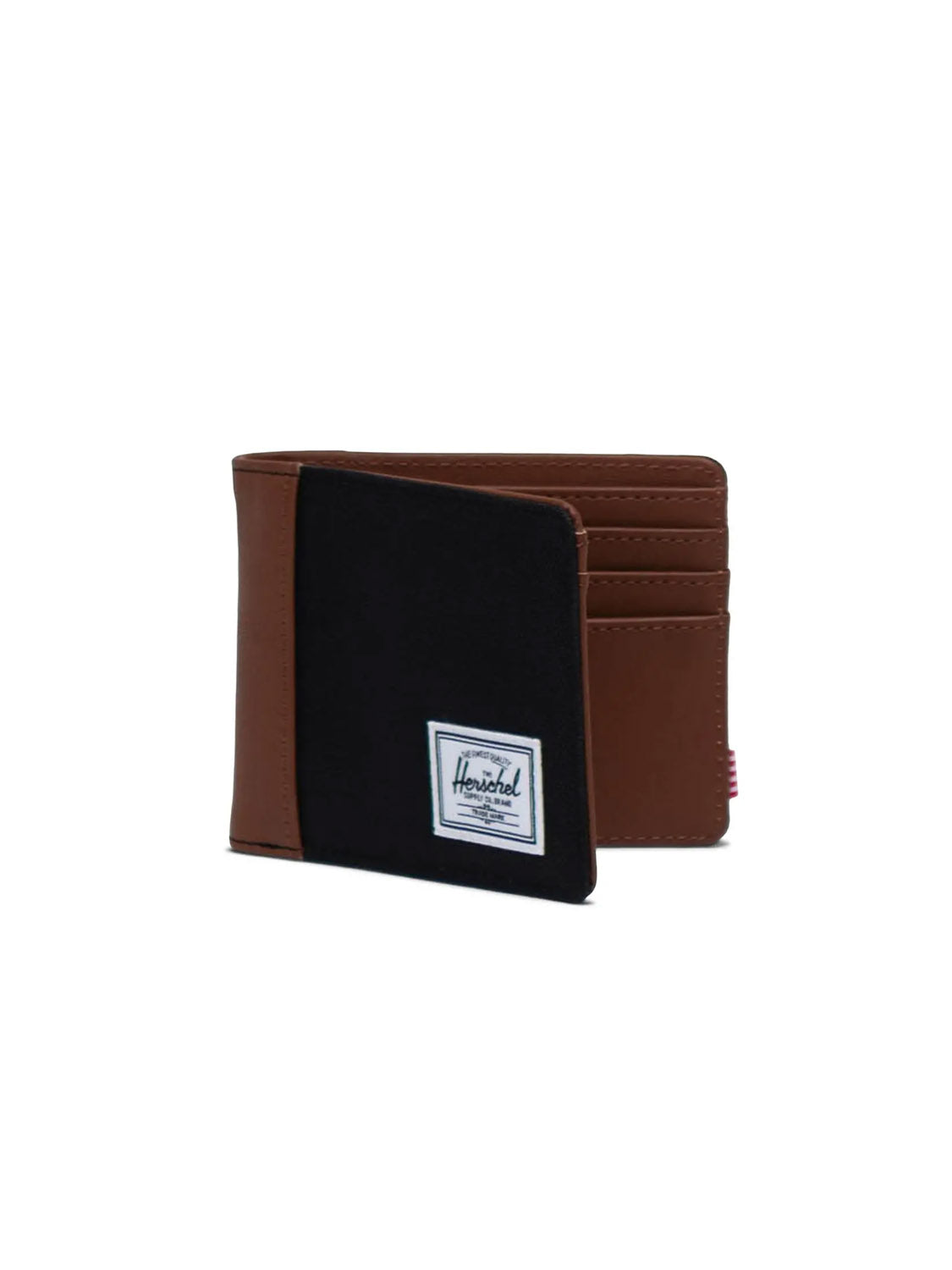 The Herschel Hank Wallet is a brown and black bi-fold featuring a white rectangular brand label on the front. Shown open against a white background, it reveals multiple interior card slots.