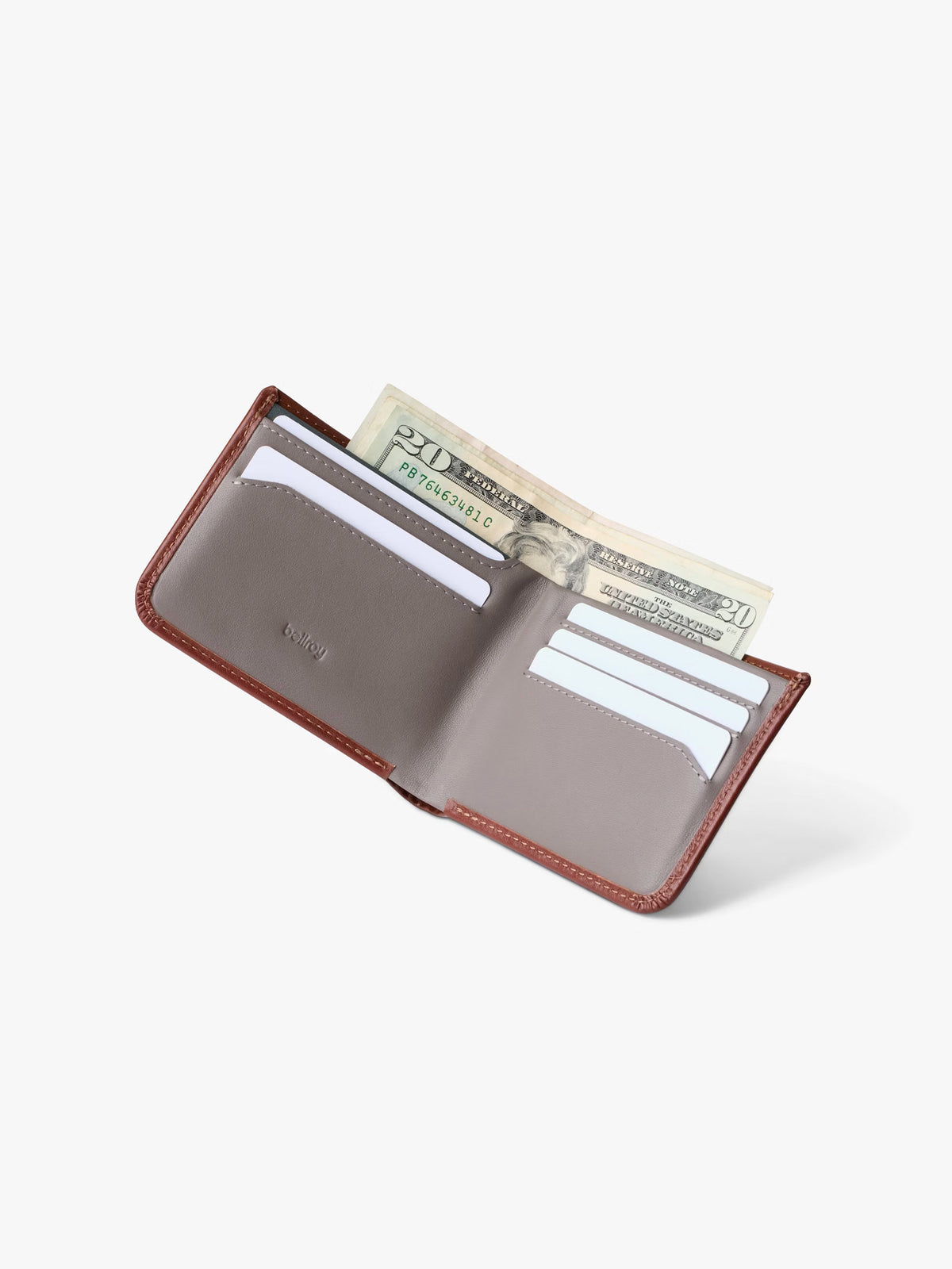 The Bellroy Hide and Seek Low Wallet, made from brown eco-tanned leather with RFID protection, is open on a white background to reveal several cards in slots and a folded twenty-dollar bill in the cash compartment.