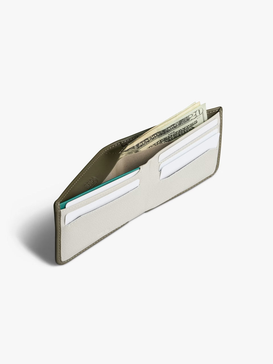 The Bellroy Hide and Seek Low Wallet, crafted from eco-tanned leather, is shown open on a white background with paper bills and several cards inside.