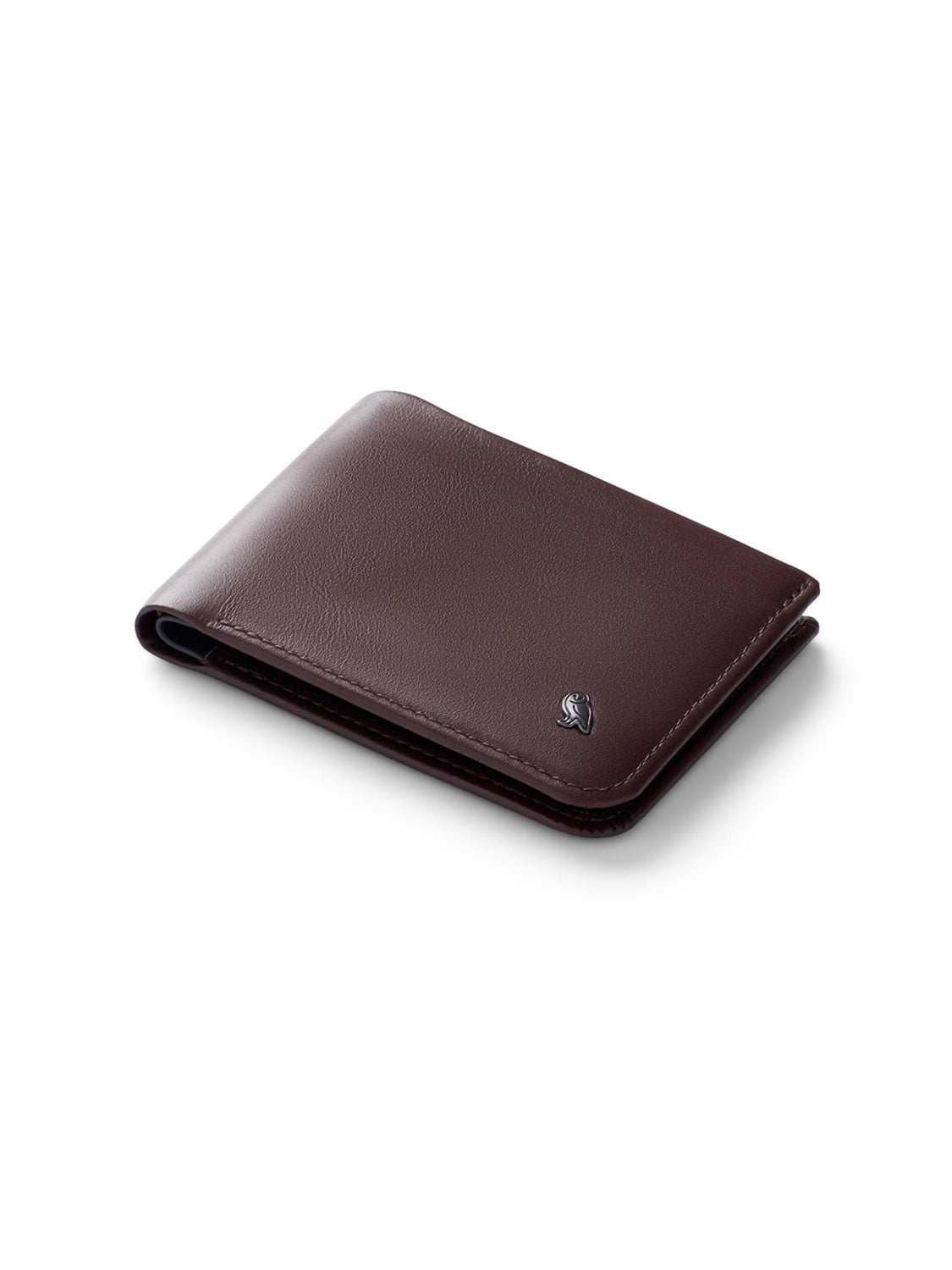 The Bellroy Hide and Seek Low Wallet, in brown eco-tanned leather, features RFID protection and a small metallic emblem on the lower right corner against a white background.