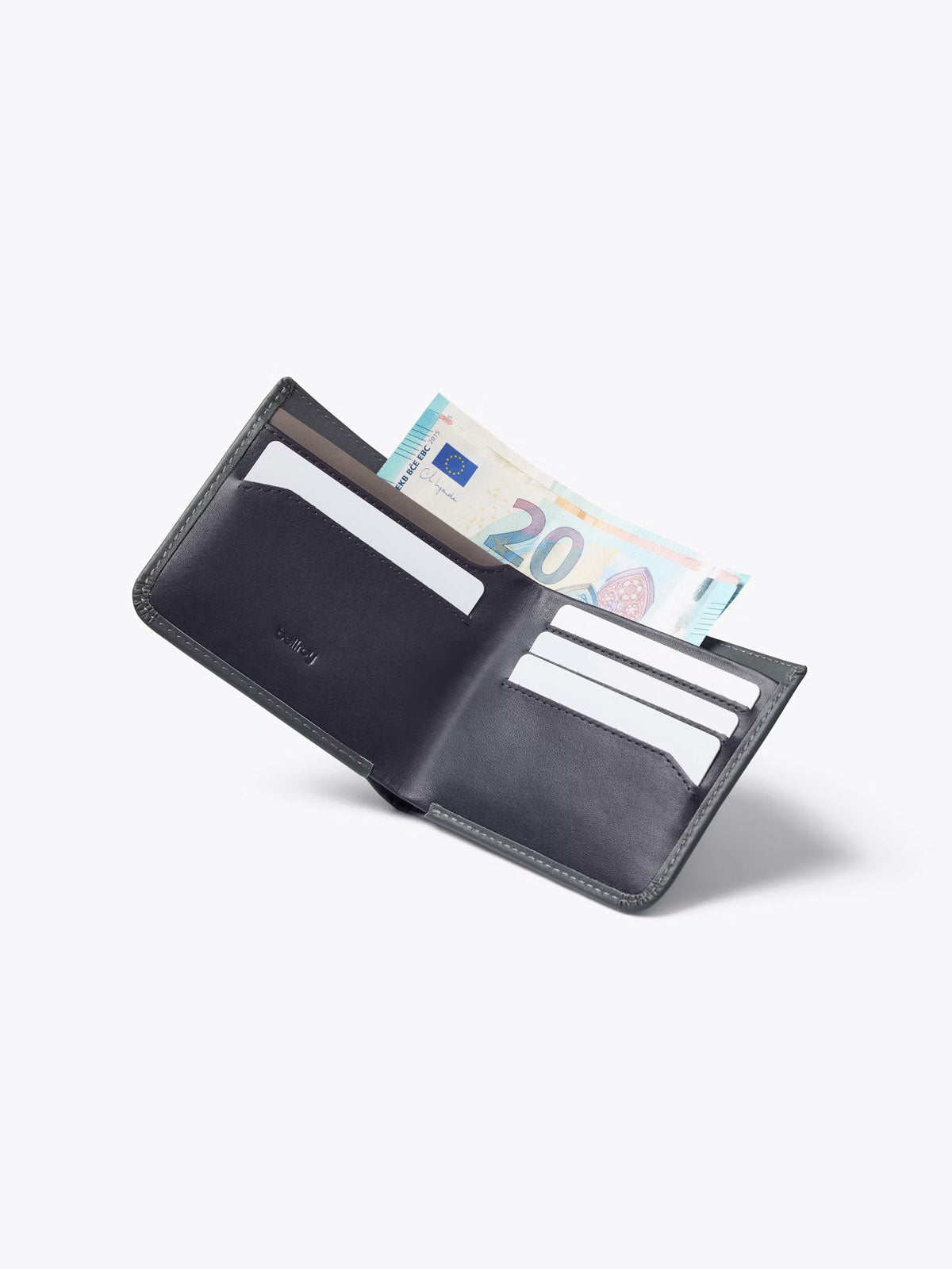 The Bellroy Hide and Seek Low Wallet, crafted in slim black leather, is shown open against a plain white background with several card slots and a partially visible 20 euro note in the cash compartment.