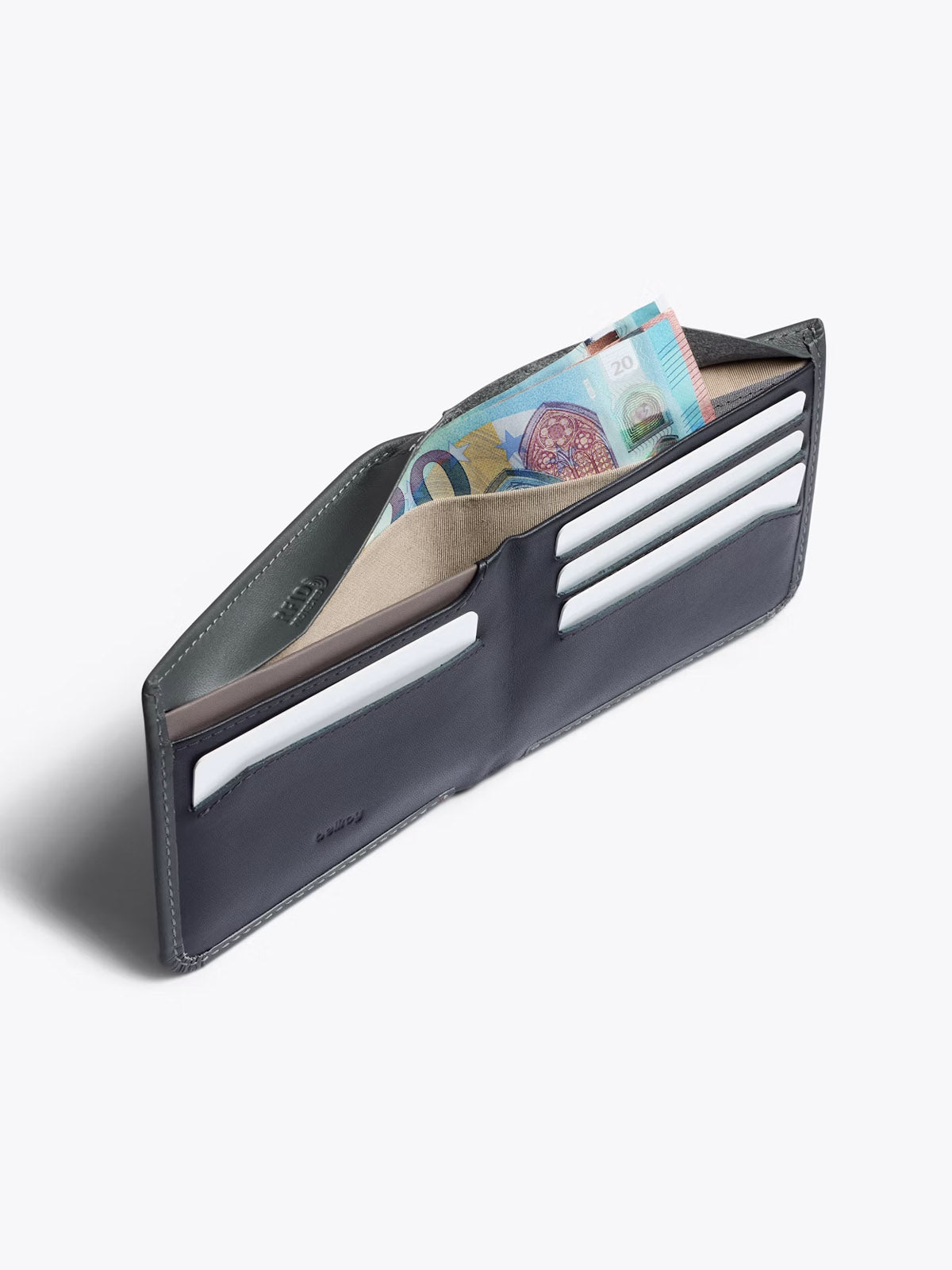 The Bellroy Hide and Seek Low Wallet, shown open in dark gray eco-tanned leather, features multiple card slots holding cards and a compartment with Australian banknotes, displayed on a plain white background.
