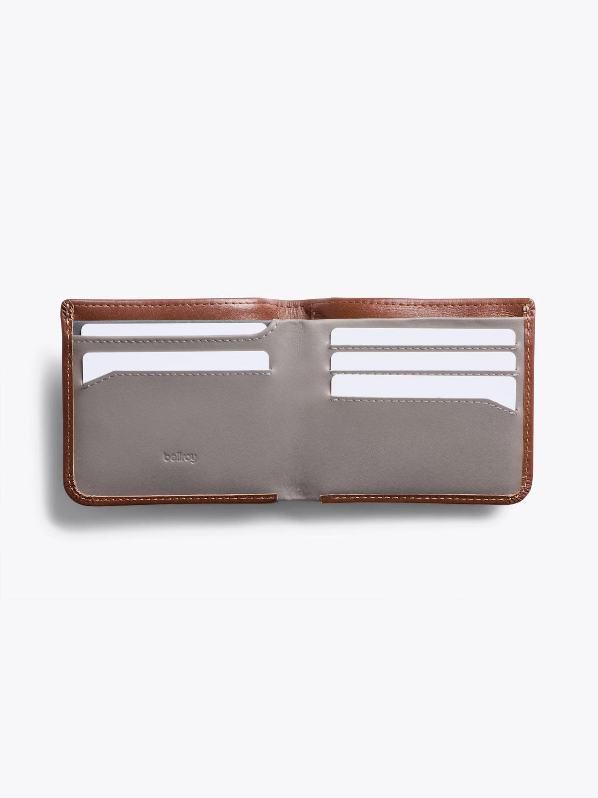 The Bellroy Hide and Seek Low Wallet, in open brown and gray eco-tanned leather, features six visible card slots with white cards, displayed against a plain white background.