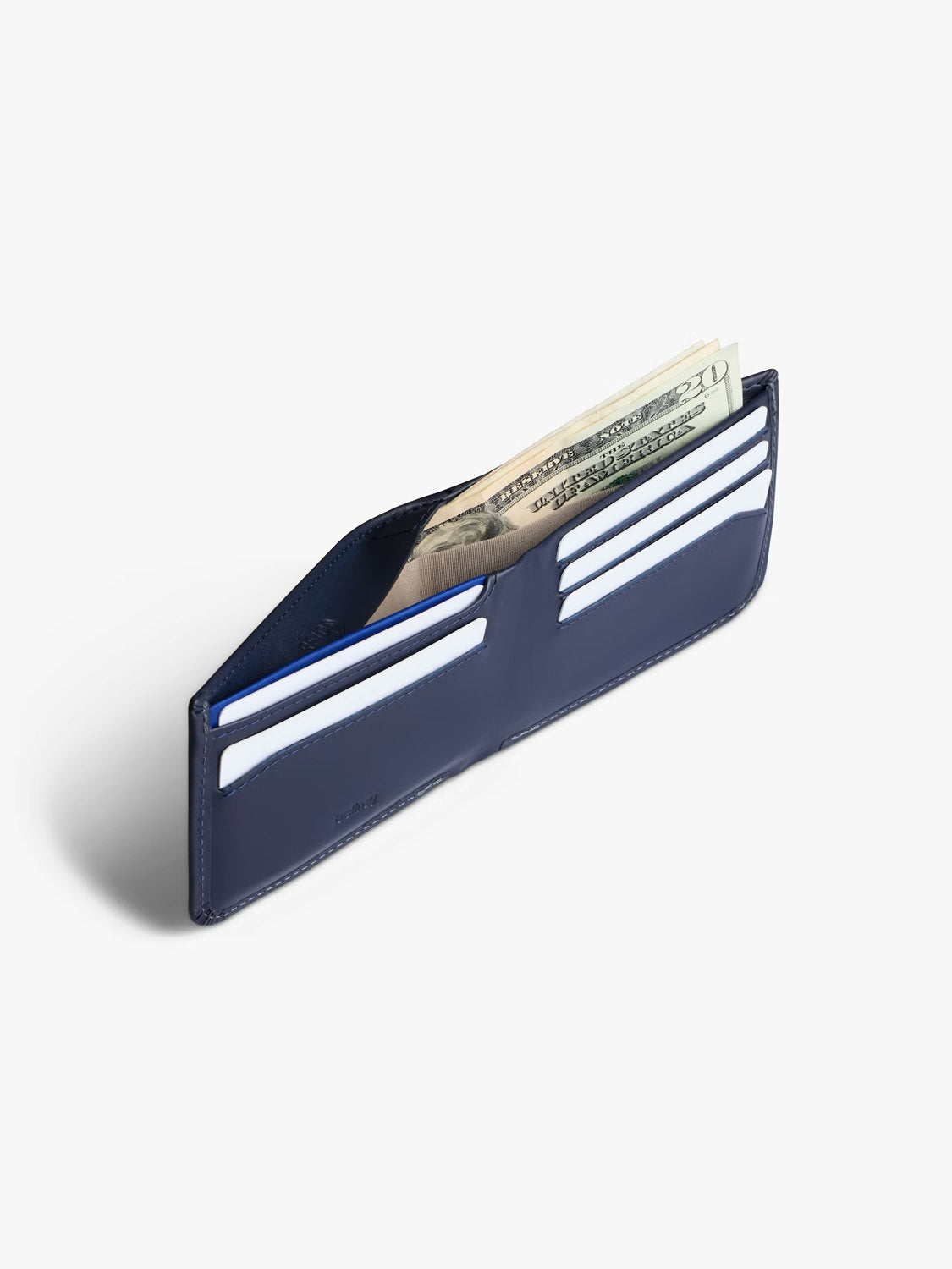 The Bellroy Hide and Seek Low Wallet, crafted from eco-tanned leather in navy blue, features multiple credit card slots and RFID protection. It securely holds cards and folded U.S. dollar bills.