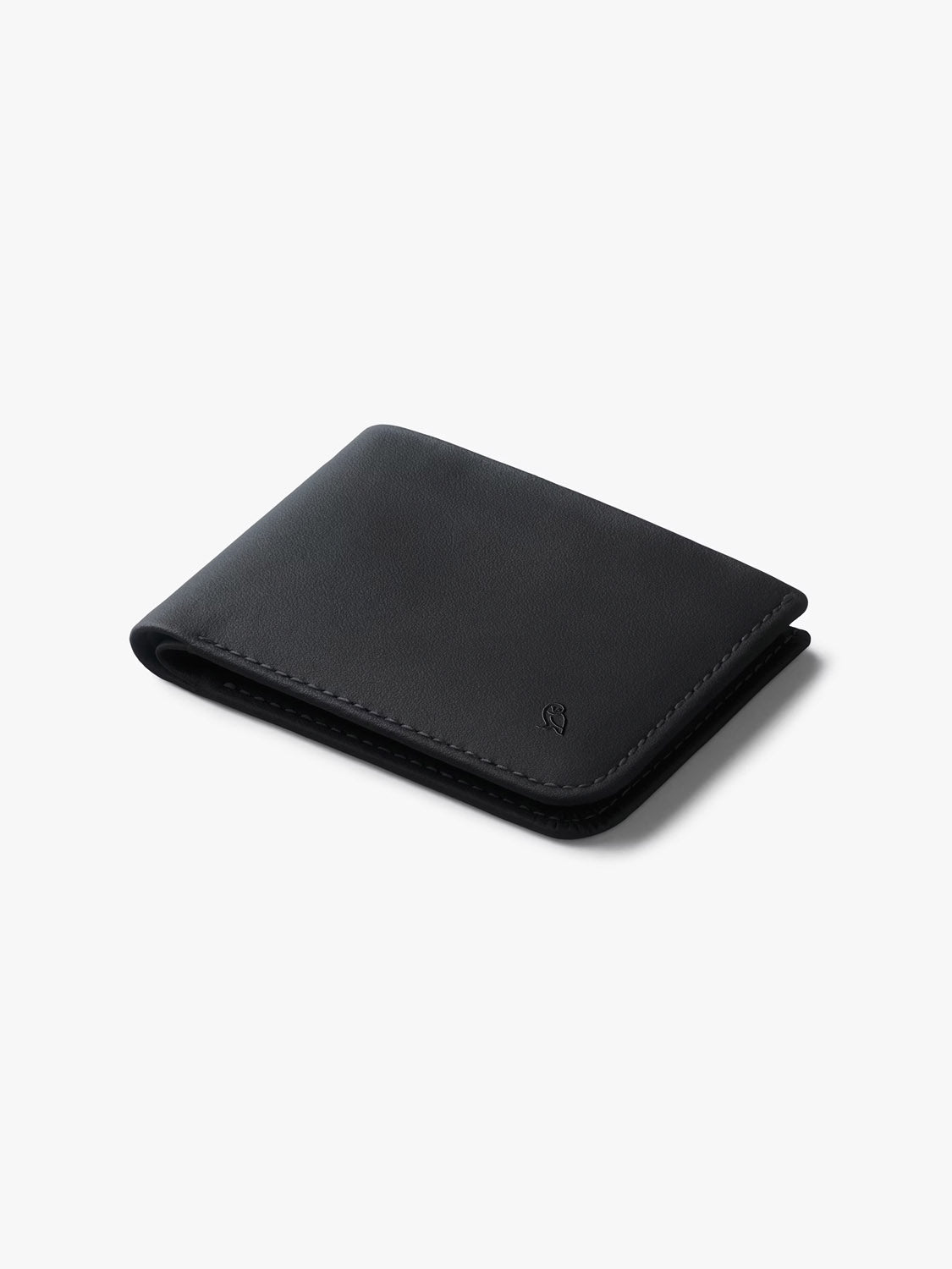The Bellroy Hide &amp; Seek Innovera™ Edition is a sleek black leather wallet with minimal stitching, RFID protection, and is showcased on a plain white background.