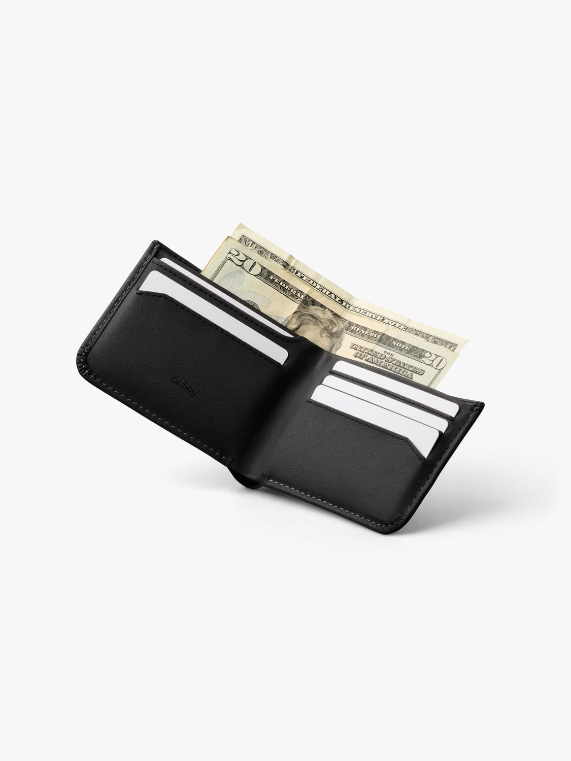 A Bellroy Hide & Seek Innovera™ Edition wallet in black leather alternative is open on a plain white background, revealing several white cards, two $20 bills, and built-in RFID protection.