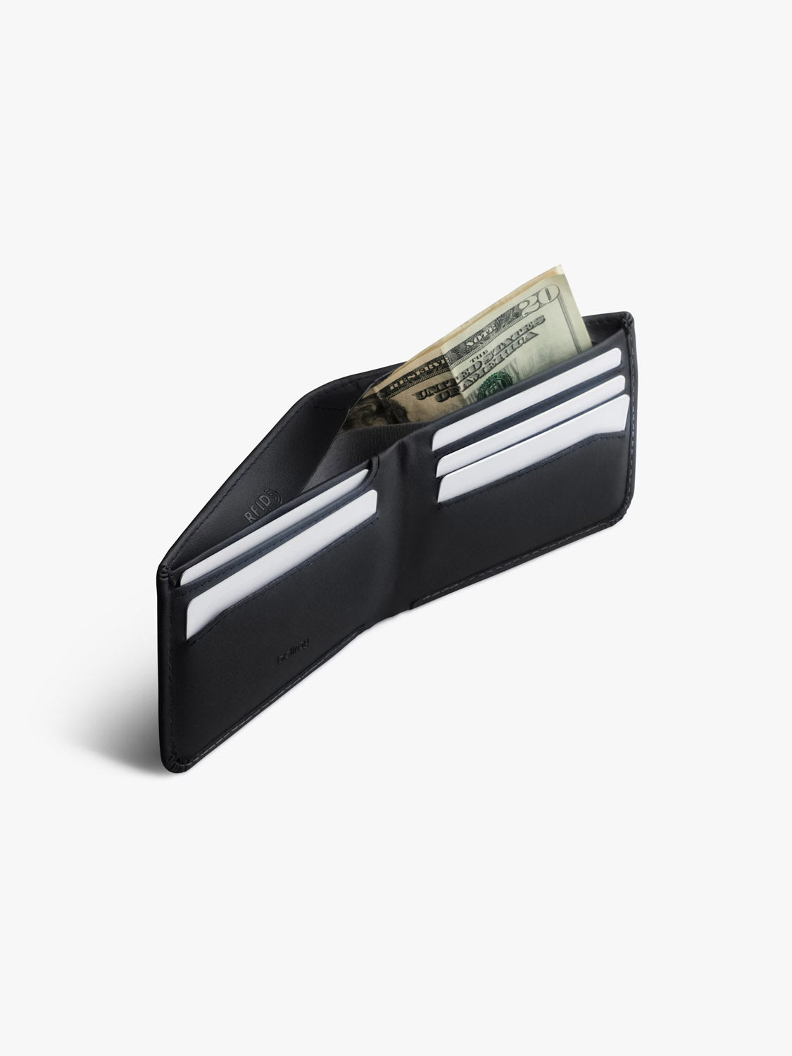 A Bellroy Hide & Seek Innovera™ Edition wallet lies open on a white background, revealing several card slots with white cards and cash, including $20 and $10 bills. This sleek black wallet provides style plus RFID protection for your essentials.