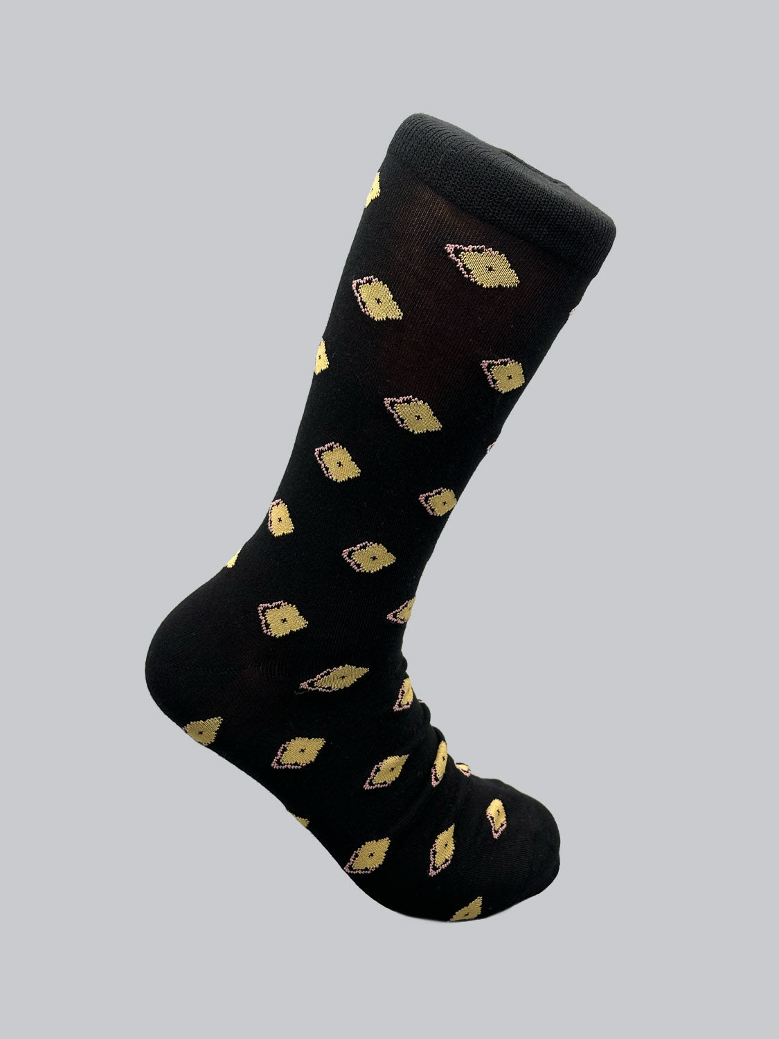 The Keda Graphic Socks by ID Menswear feature a vertical black design adorned with small yellow lemons, crafted from combed cotton, and set against a plain gray background.