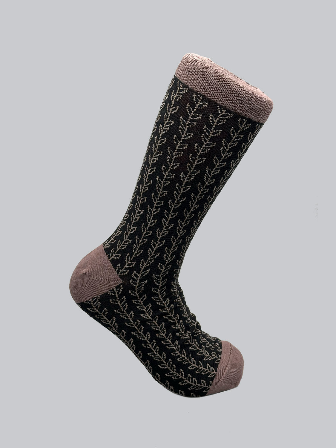Introducing Kombu Graphic Socks by ID Menswear: a single sock made from soft combed cotton, featuring a dark base with a light vine-like pattern. The toe, heel, and cuff offer a solid light contrast. Breathable and stylish, its perfect for enhancing any outfit.