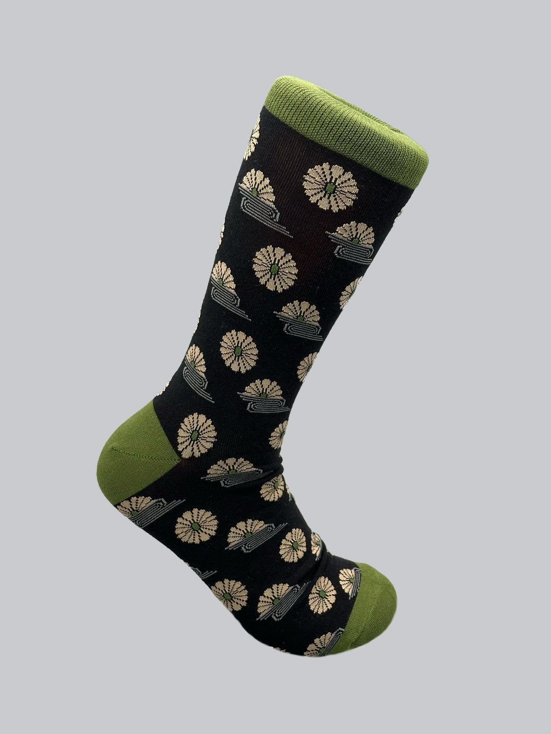 ID Menswears Kiku Graphic Sock features a plain grey background with light-colored gears and spaceships, crafted from premium combed cotton in black, accented by a green toe, heel, and cuff for ultimate comfort.