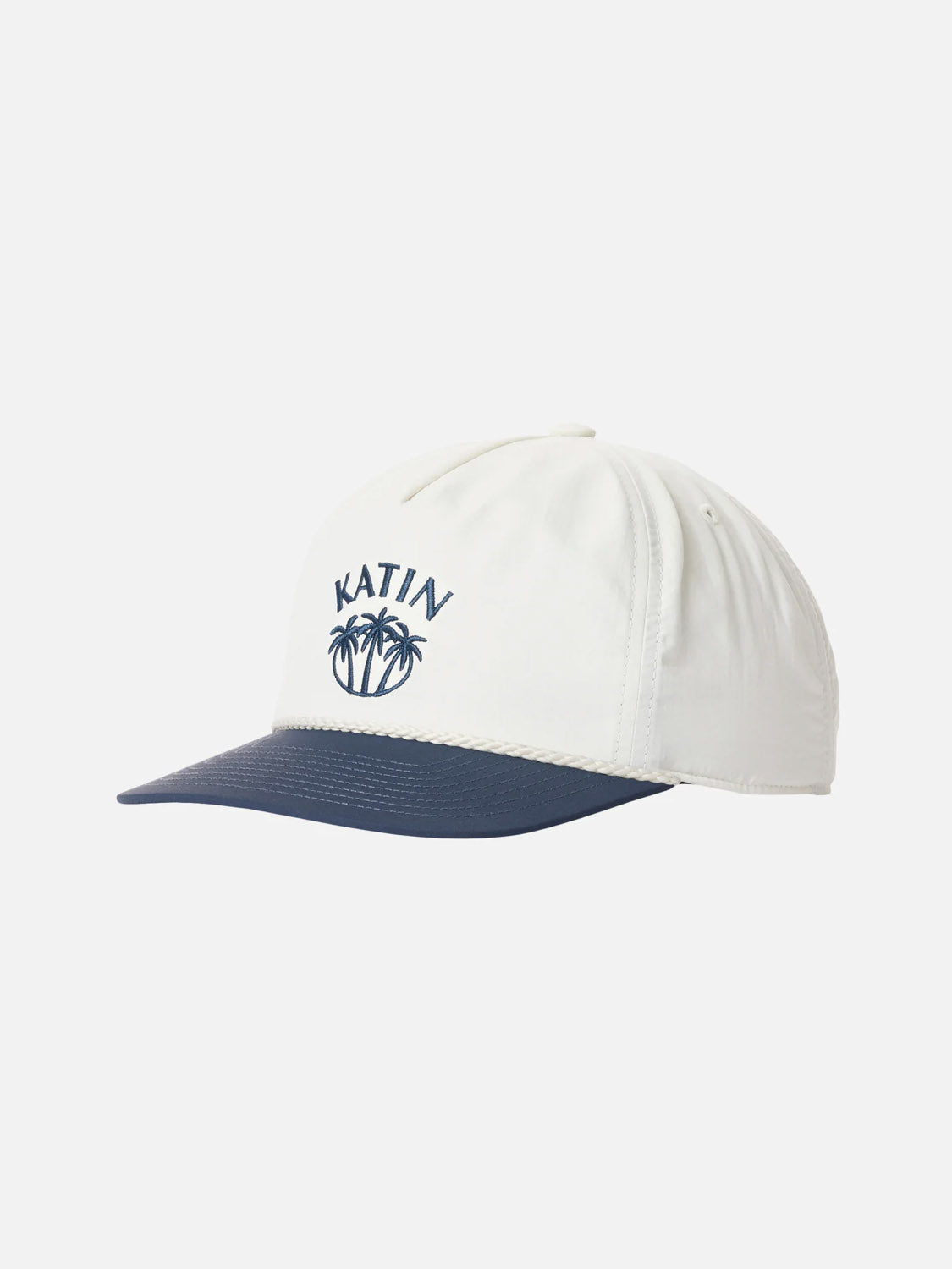 The Katin Largo Hat is a white recycled nylon cap with a navy blue brim, featuring KATIN and palm tree embroidery on the front and a snapback closure. Shown against a plain white background.