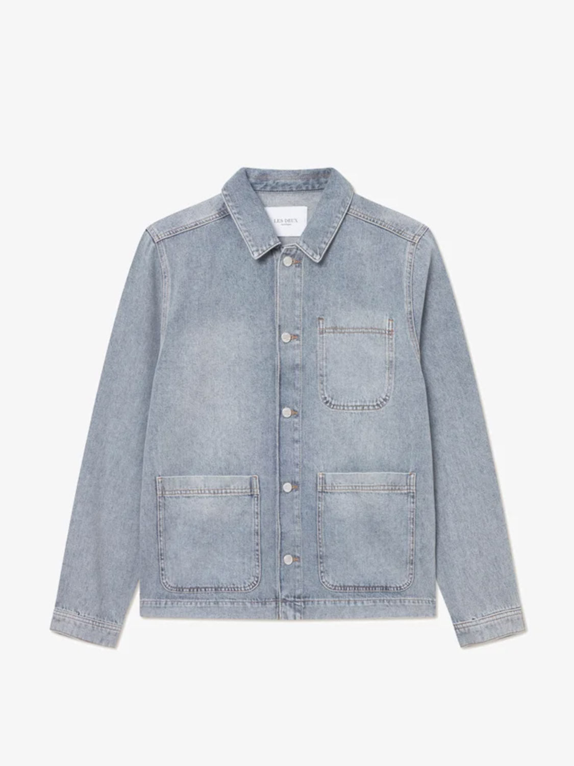 The Layton Denim Overshirt by Le Deux features light blue denim twill, a collar, front buttons, three large pockets, regular fit, long sleeves, and visible edge stitching.