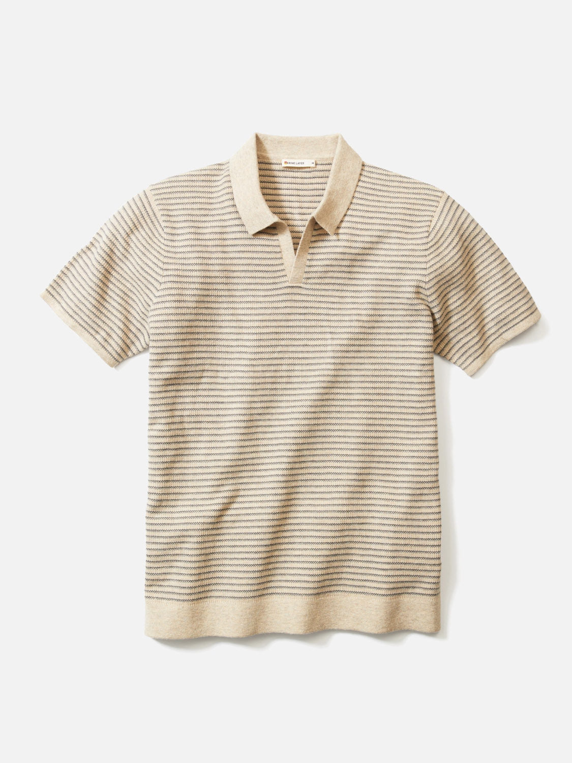 The Marine Layer Liam Sweater Polo is a short-sleeve, beige Merino wool top with light brown stripes, a collared neckline, and a relaxed fit, shown laid flat on a white background.
