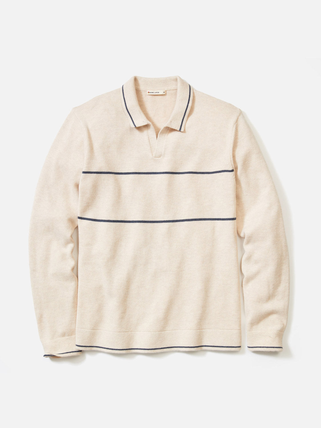 The Liam Long Sleeve Sweater Polo by Marine Layer is a cream Merino wool knit with a Johnny collar and two thin navy stripes across the chest and near the hem, shown laid flat on a white background.