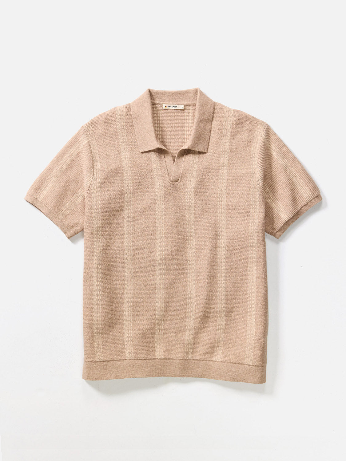 The Marine Layer Liam Sweater Short Sleeve Polo is a beige knit polo featuring a collar, short sleeves, and subtle vertical stripes—stylish and versatile, shown flat on a white background.