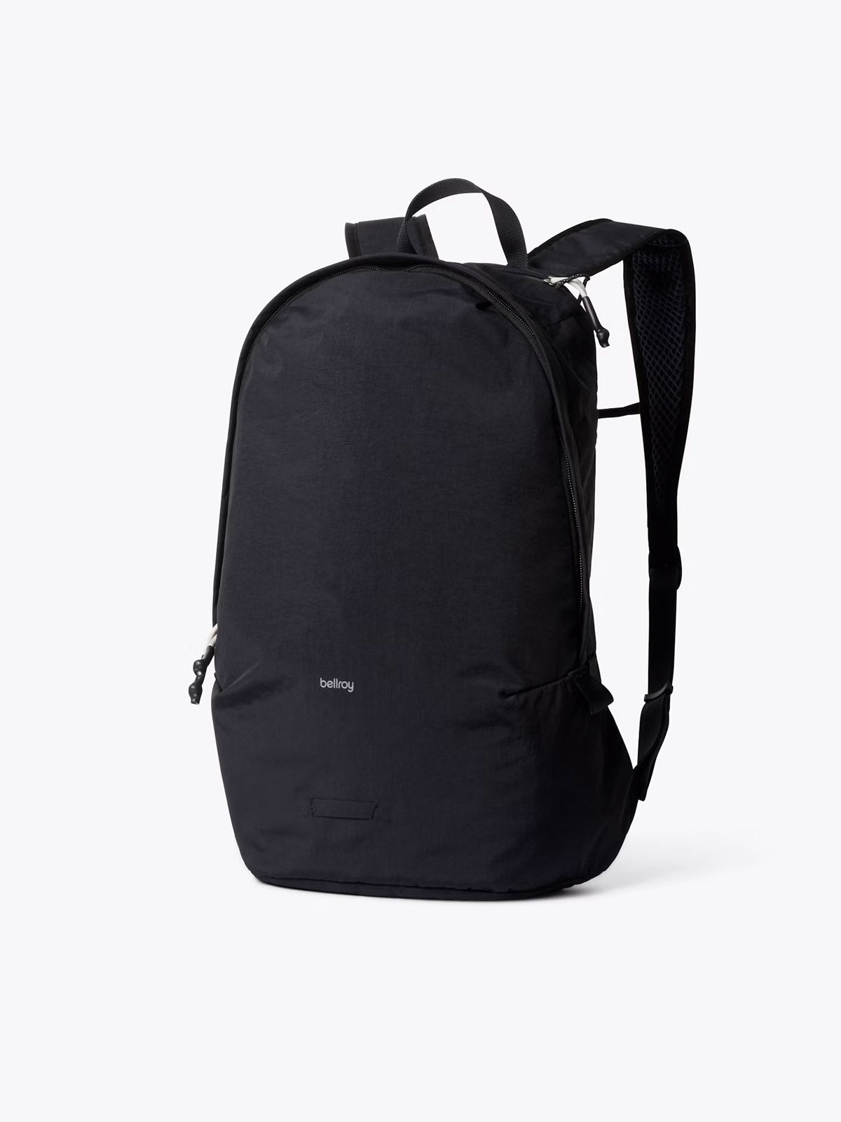 The Bellroy Lite Daypack - 20L is a lightweight, minimalist travel backpack with two shoulder straps and a small front logo, displayed upright on a light grey background.
