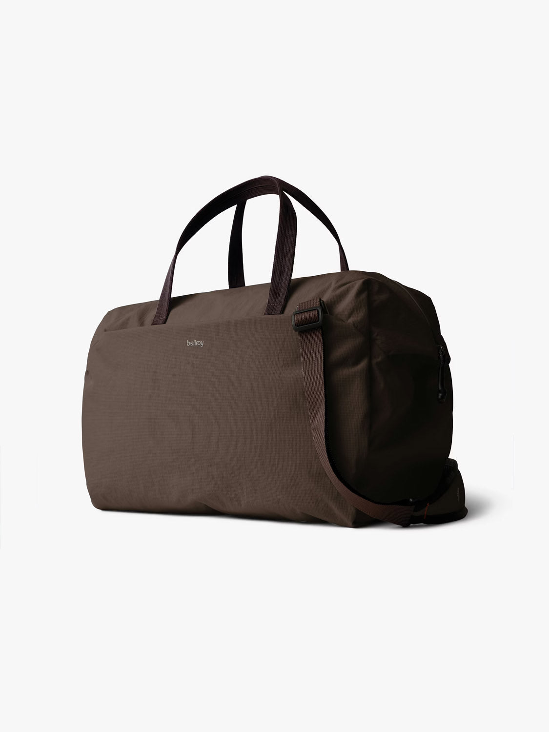 The Bellroy Lite Duffle Bag - 30L features a brown recycled exterior, black handles, a small side logo, and an adjustable shoulder strap, shown on a plain white background.
