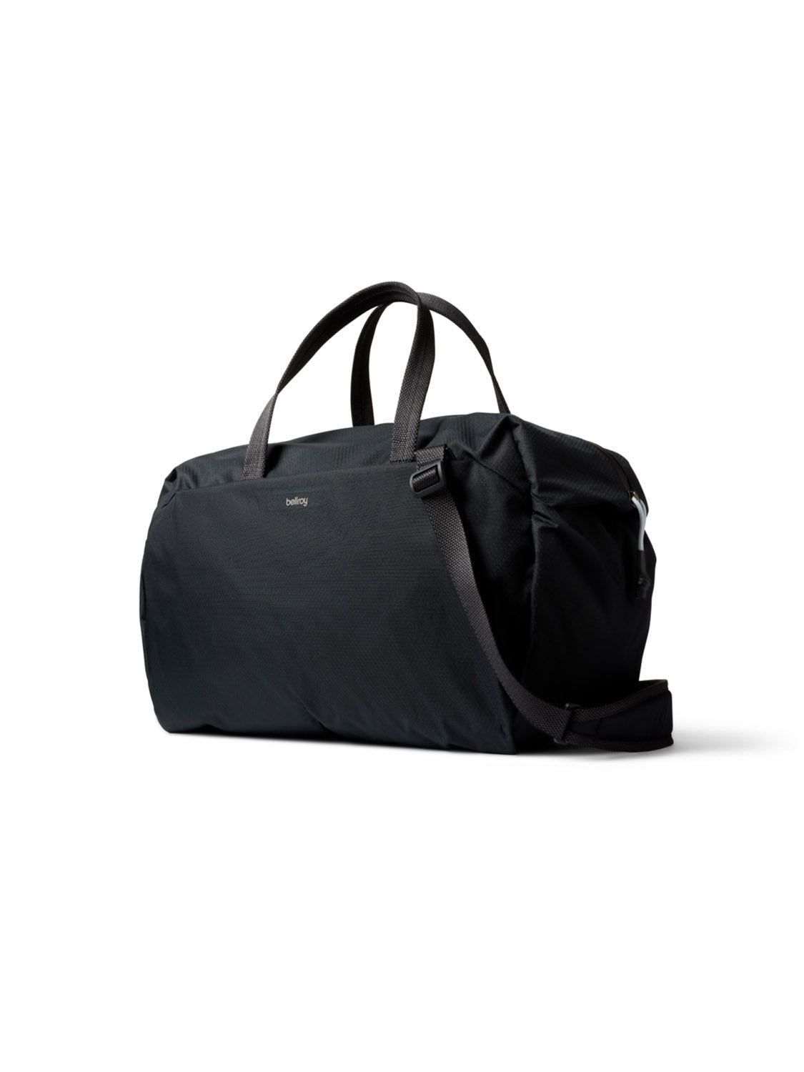 The Bellroy Lite Duffle Bag - 30L is a black, lightweight travel bag with short handles and a detachable shoulder strap. Its spacious, minimalist design makes it ideal for carrying your essentials on the go. Shown against a white background.