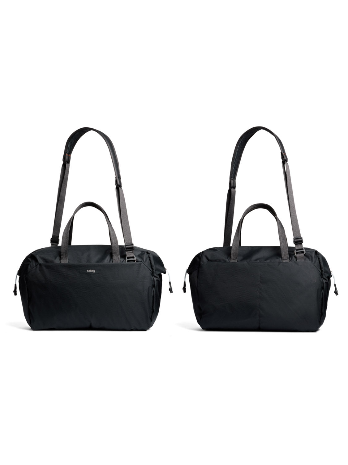 Two Bellroy Lite Duffle Bag - 30L in black, made from recycled materials, are displayed side by side on a white background. Each features short handles and adjustable shoulder straps for minimalist, lightweight travel.