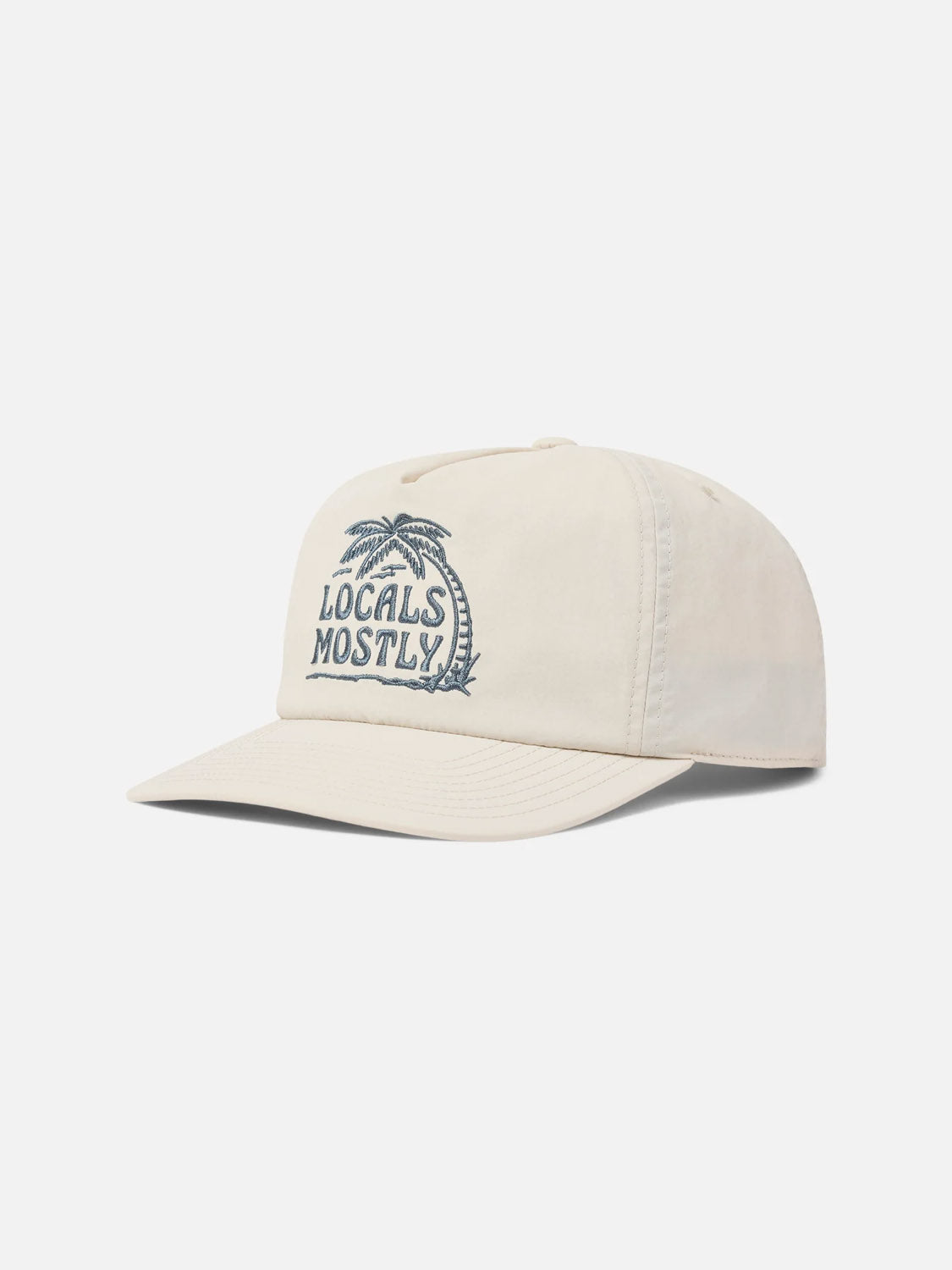 The Katin Locals Hat is a beige recycled nylon cap with a curved brim, featuring "Locals Mostly" embroidery and a blue palm tree on the front panel, shown against a plain white background.