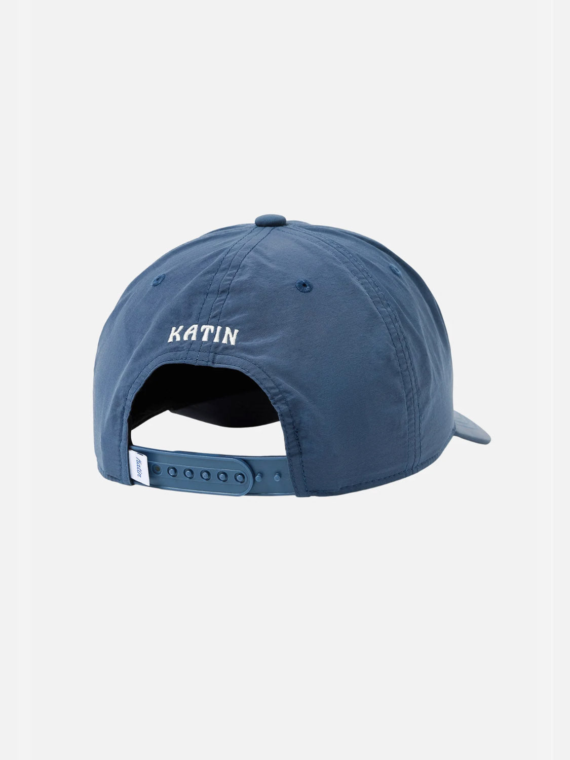 The Katin Locals Hat is a blue snapback shown from the back, featuring an adjustable strap and white “KATIN” embroidery above the opening—crafted from recycled nylon with Locals Mostly embroidery for a unique touch.