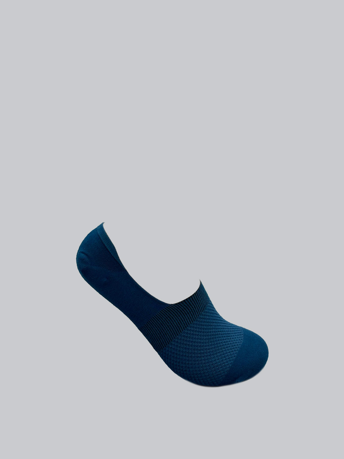 The M1 No Show Sock from ID Menswear is showcased in dark blue, crafted from combed cotton. It features a mesh pattern on the foot area and is presented against a light gray backdrop, appearing to float—ideal for low-cut shoes.