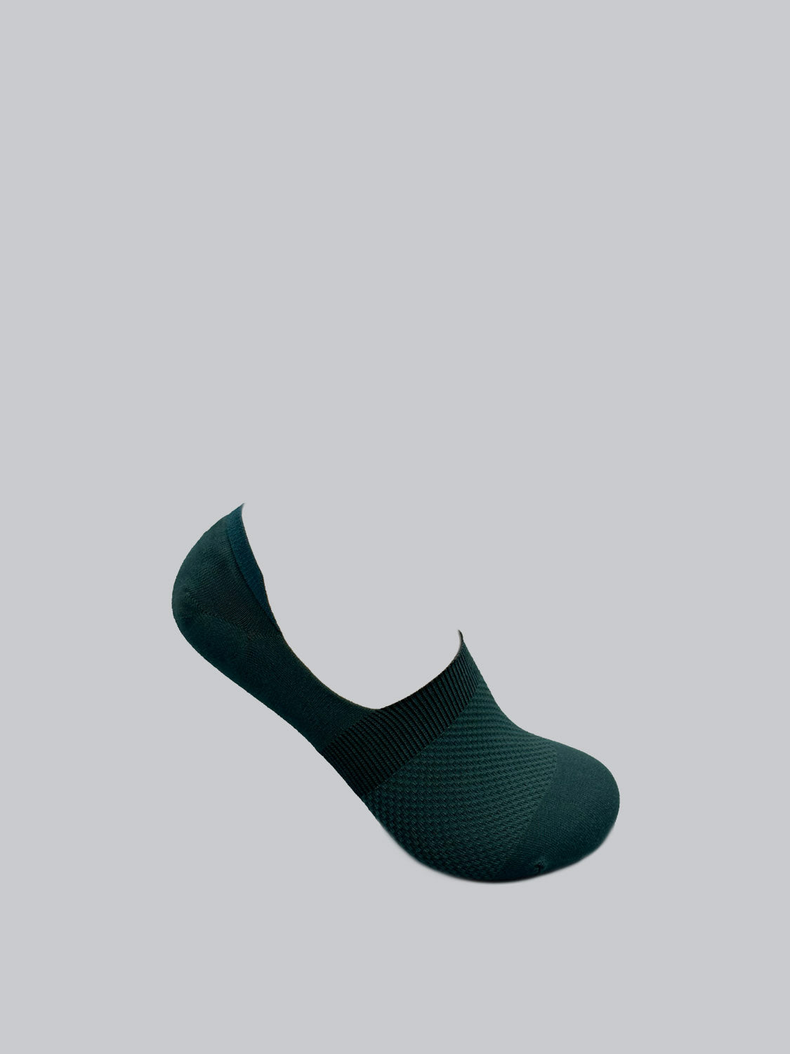 Against a light gray background, ID Menswears M1 No Show Socks in black showcase ribbed detailing around the opening and a subtle textured pattern, crafted from soft combed cotton. Perfect for low-cut shoes.