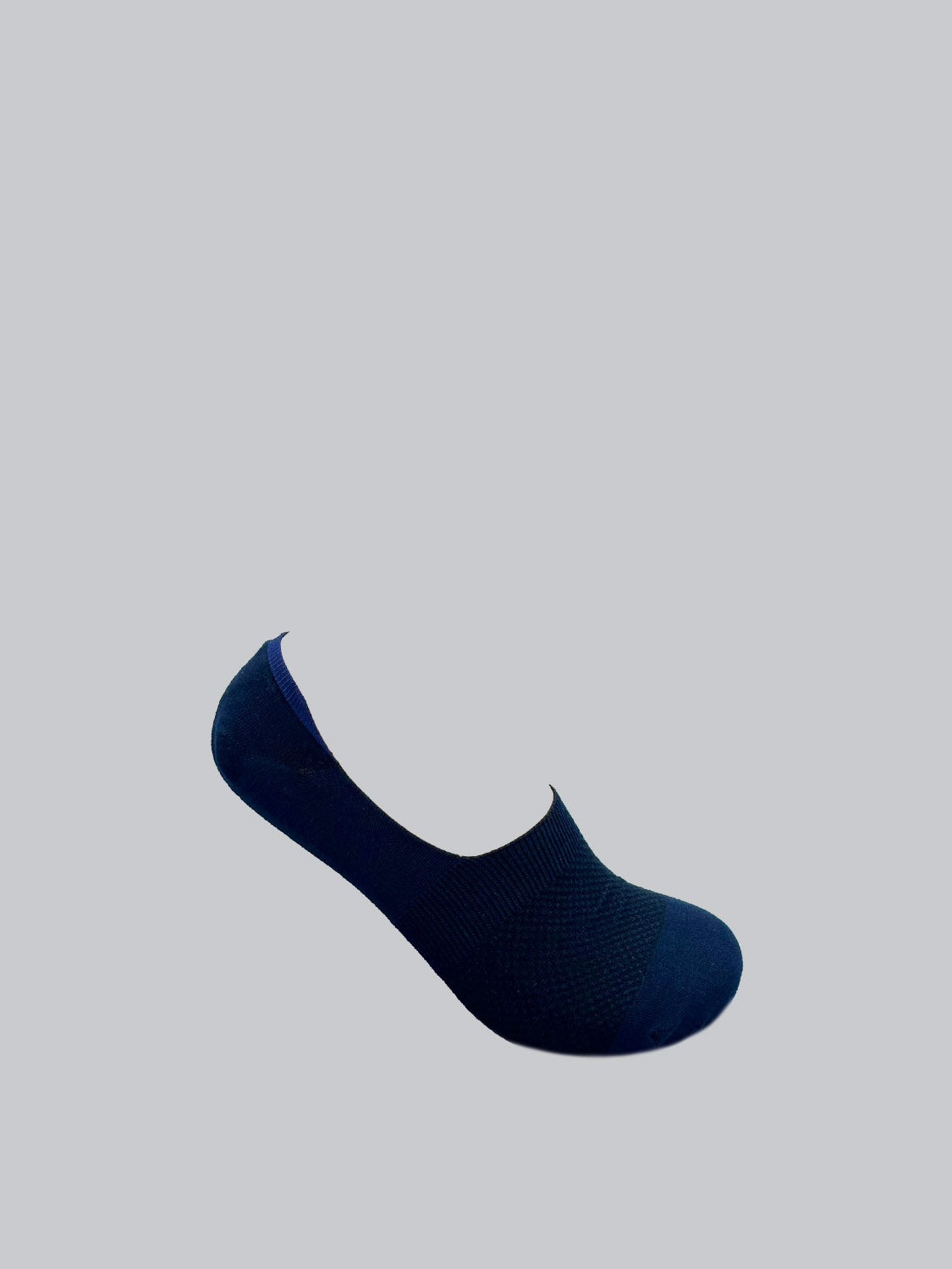 A dark blue M1 No Show Sock by ID Menswear, made from soft combed cotton, is shown against a gray background. Ideal for low-cut shoes, its sleek design features no visible patterns or logos.